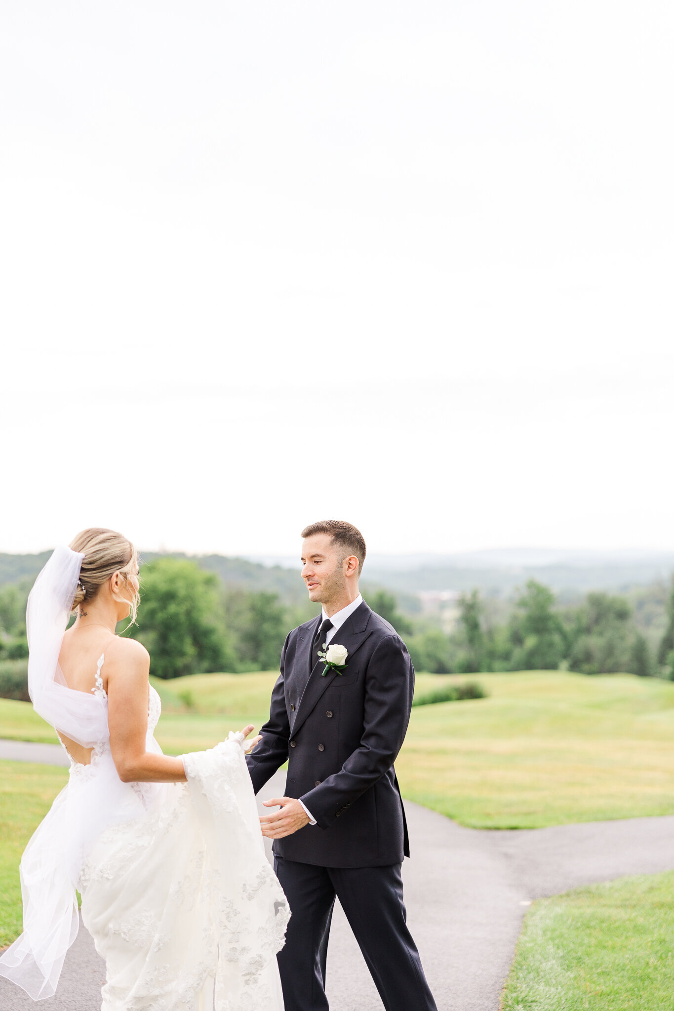 Candid first look between bride and groom at SkyView Golf Club in Sparta, New Jersey