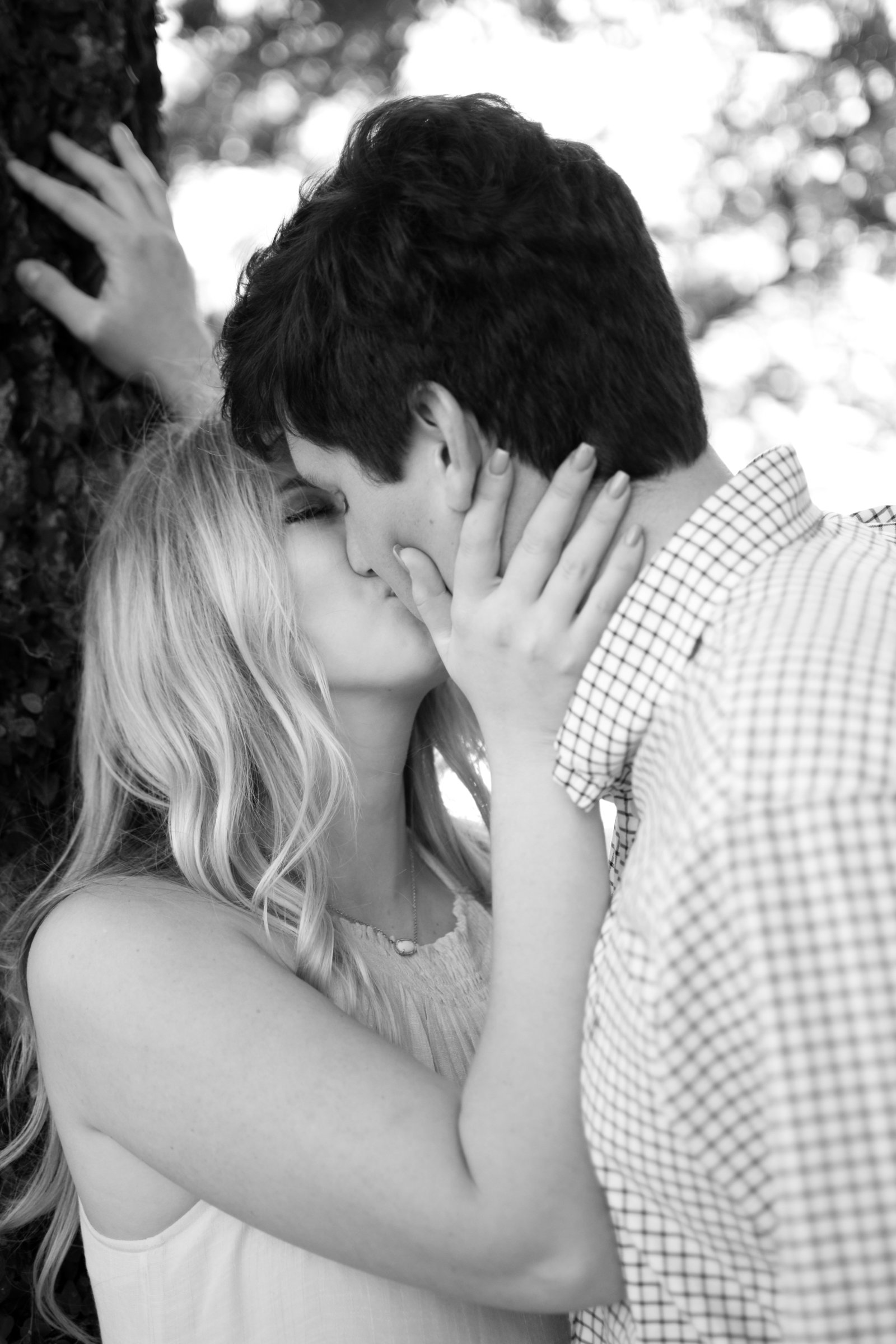 Couple kissing engagement park Jacksonville Riverfront Florida