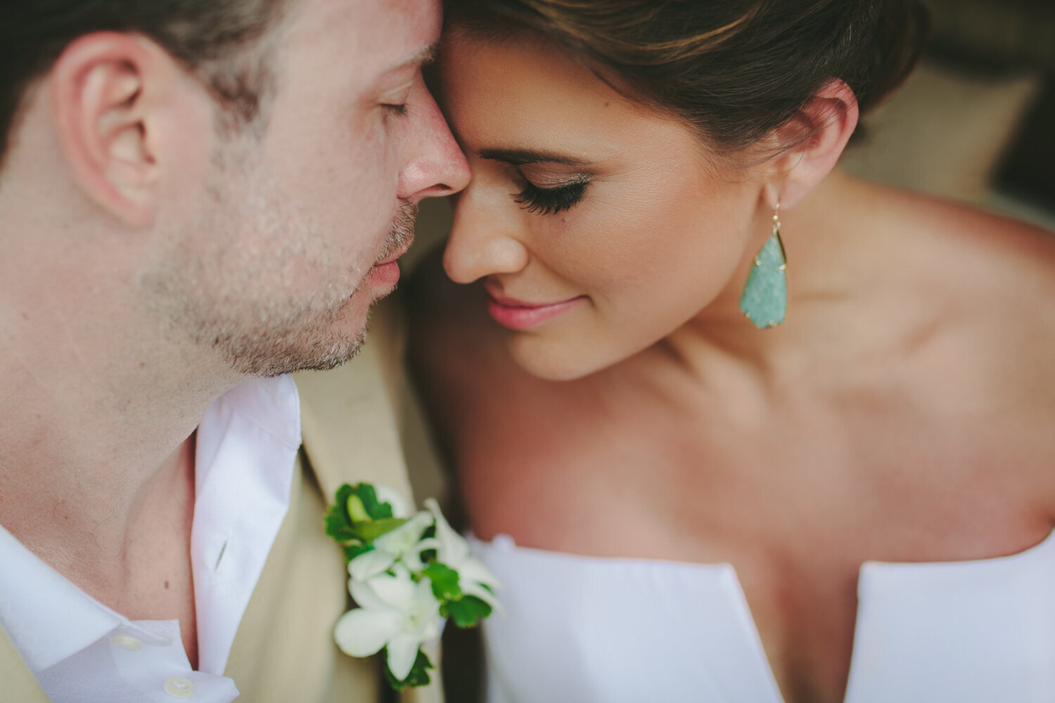 couple cuddling with gorgeous bride and turquoise earring