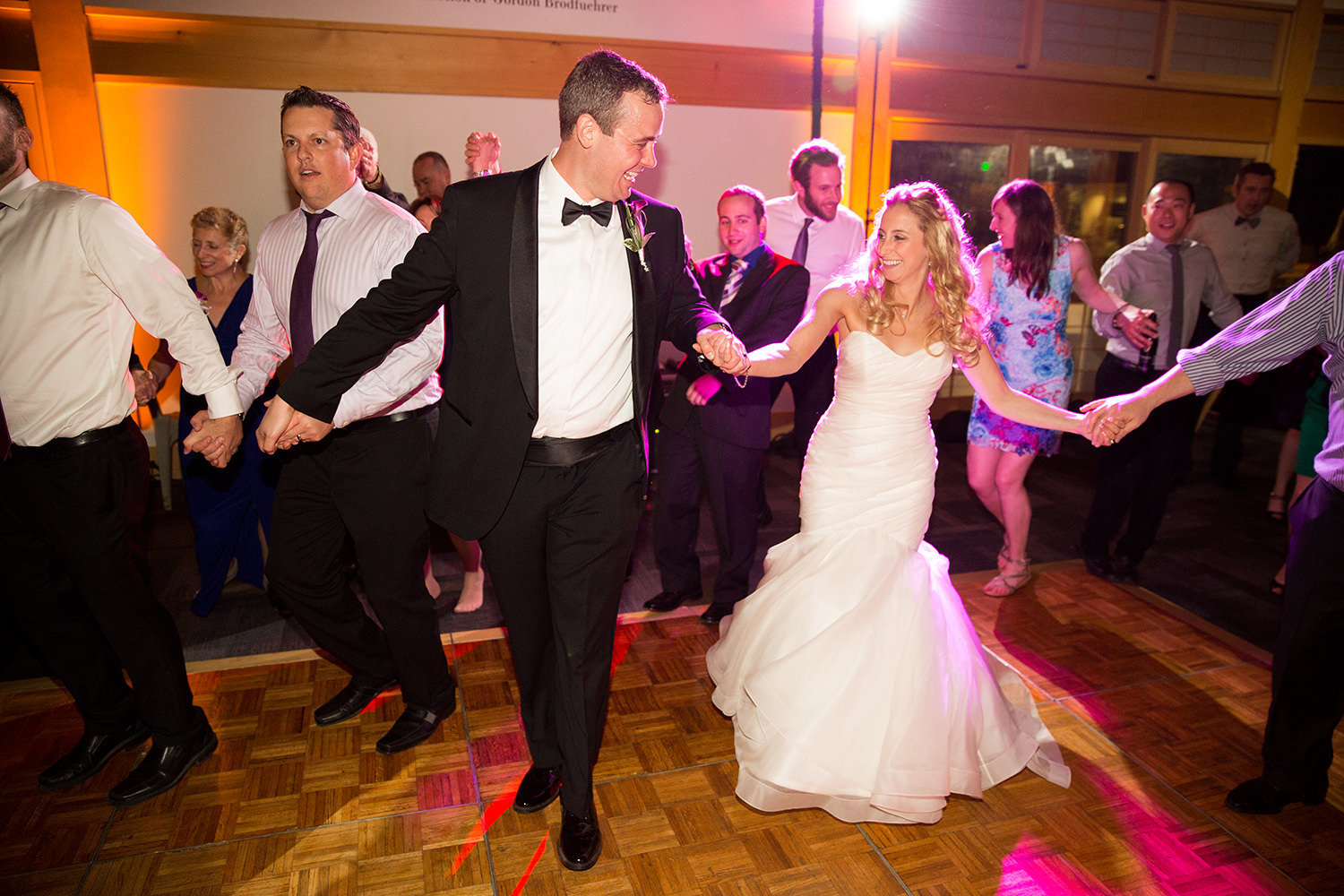 couple dancing with pink uplighting