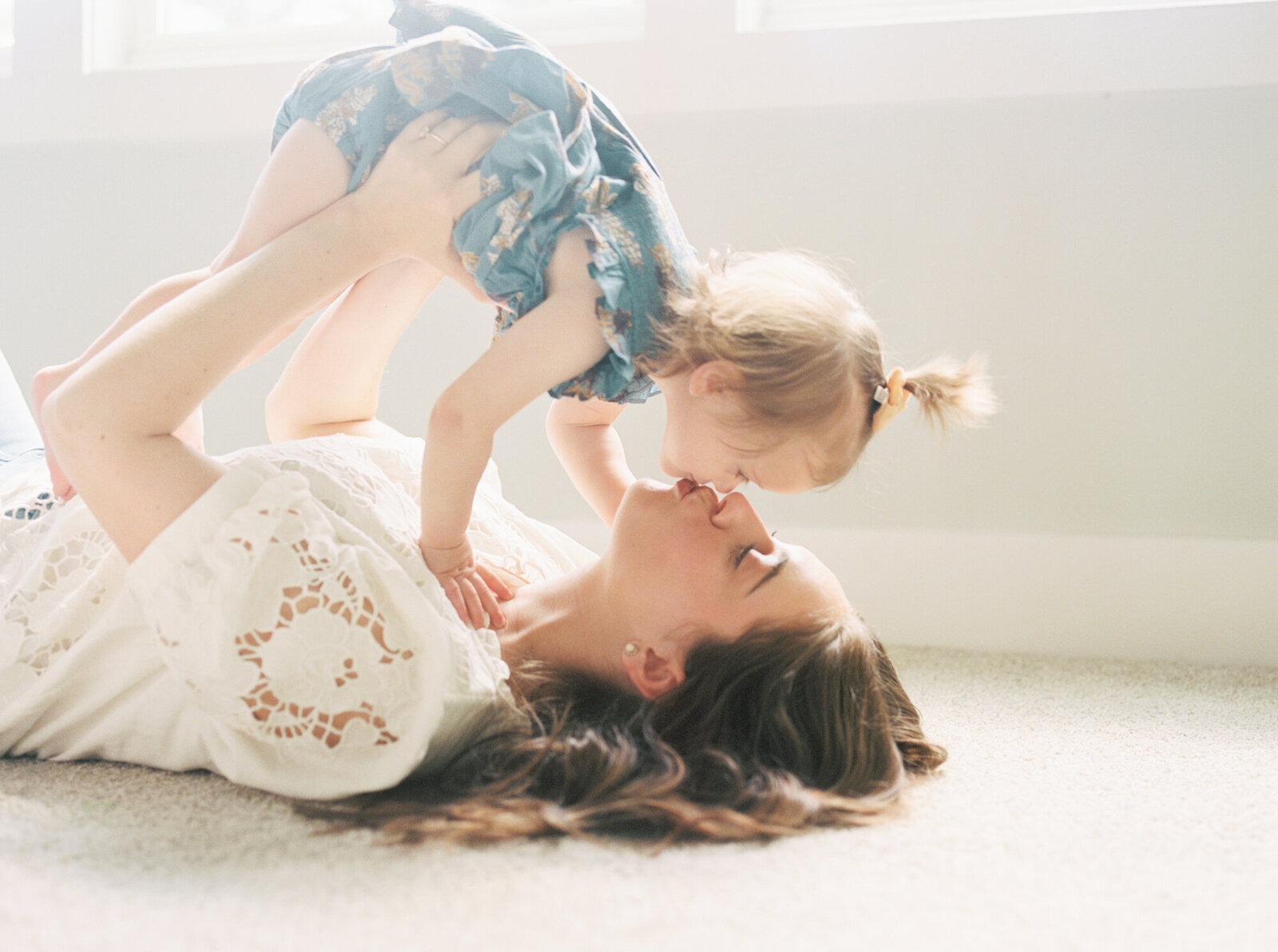 family laying on the floor during Raleigh family photos with Morgan Williams Photo