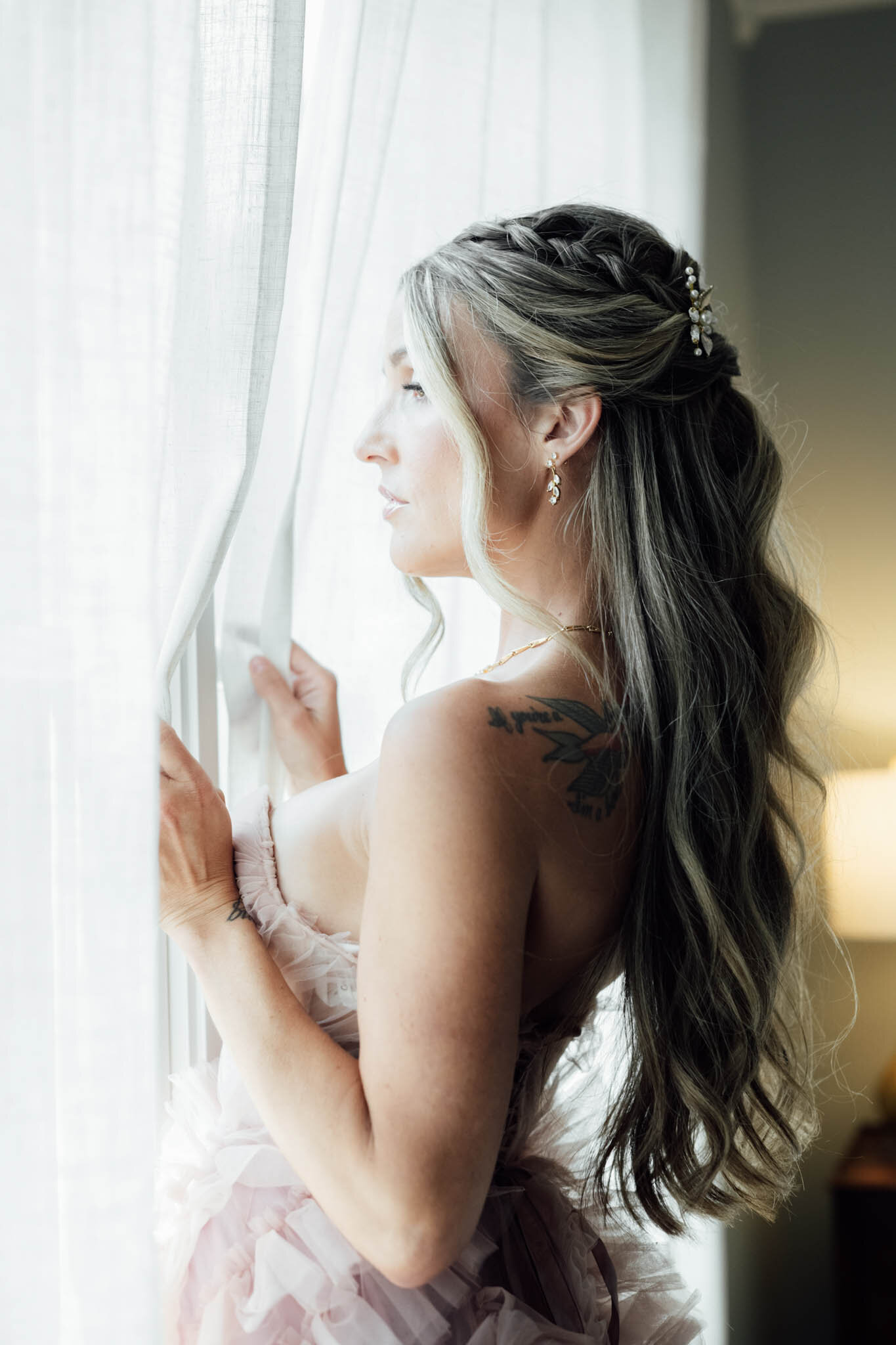 Bride in her wedding dress peeking outside