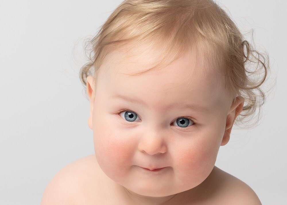 closeup-photo-of-baby-with-blue-eyes