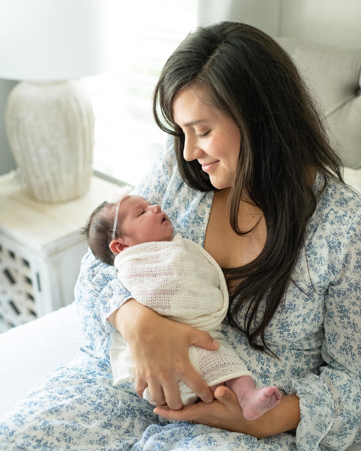 mother snuggling with newborn baby