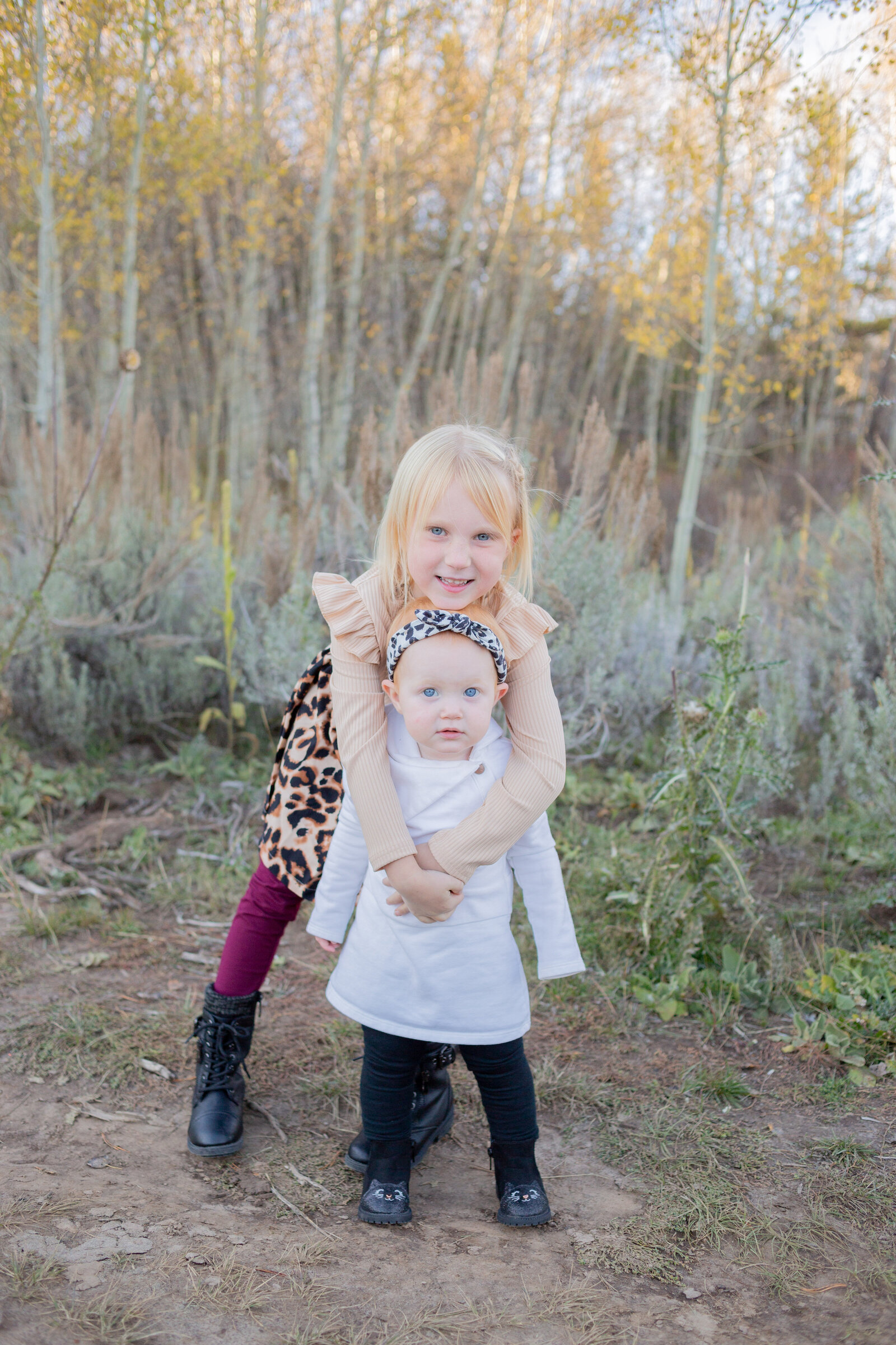 Seattle Wedding Photographer captures sister hugging while looking at camera