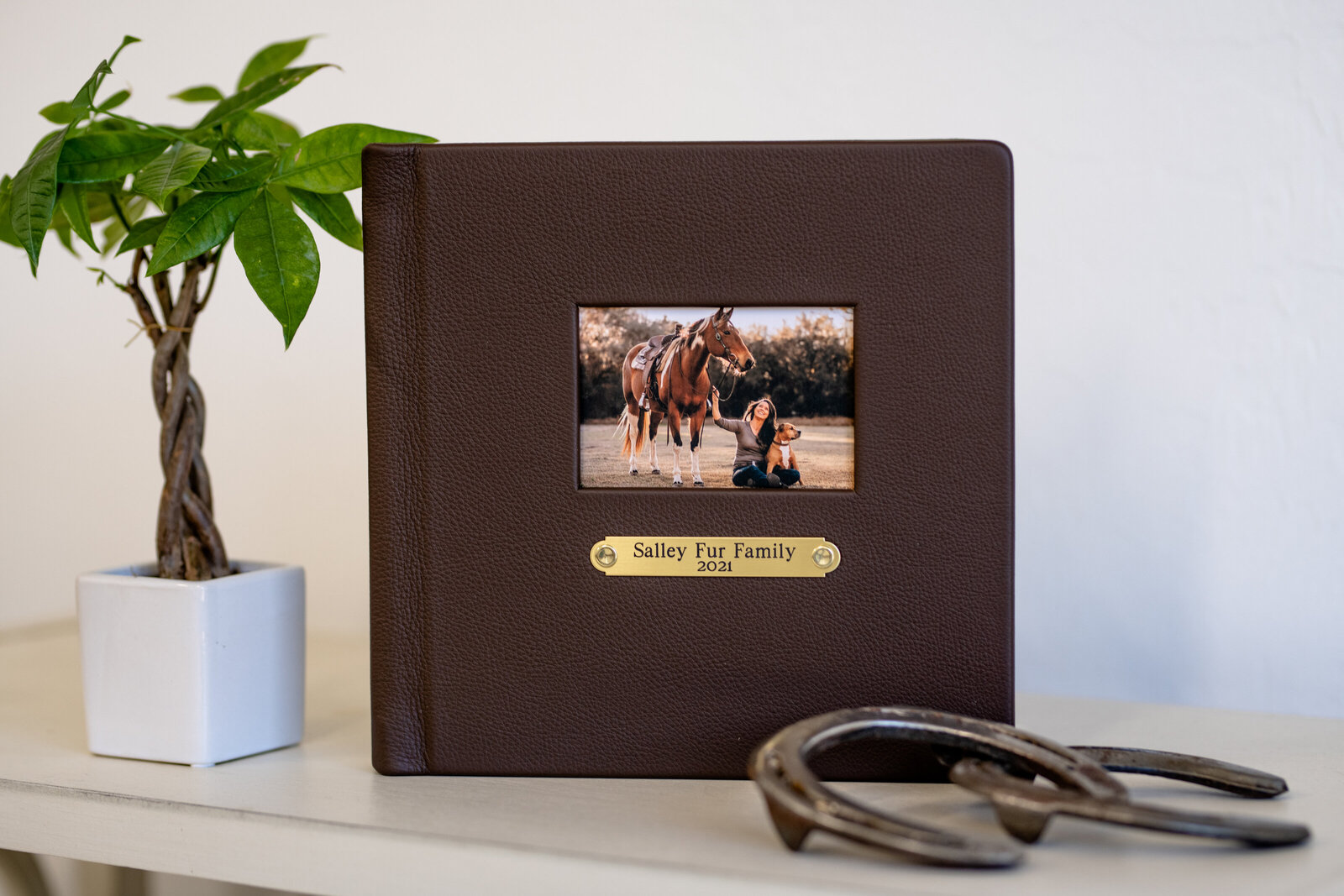 Stunning leather photo album with brass stall plate featuring Tallahassee equestrian and her dog.