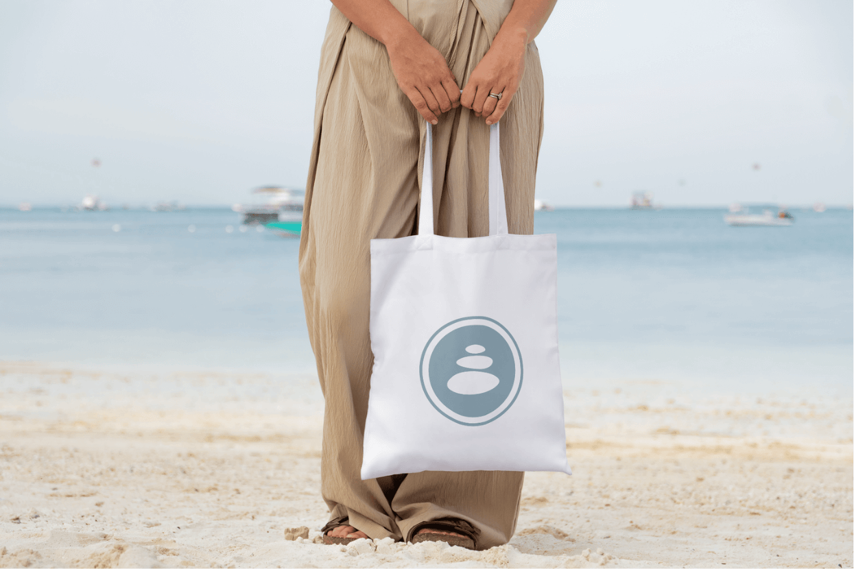 Woman holding tote bag on beach