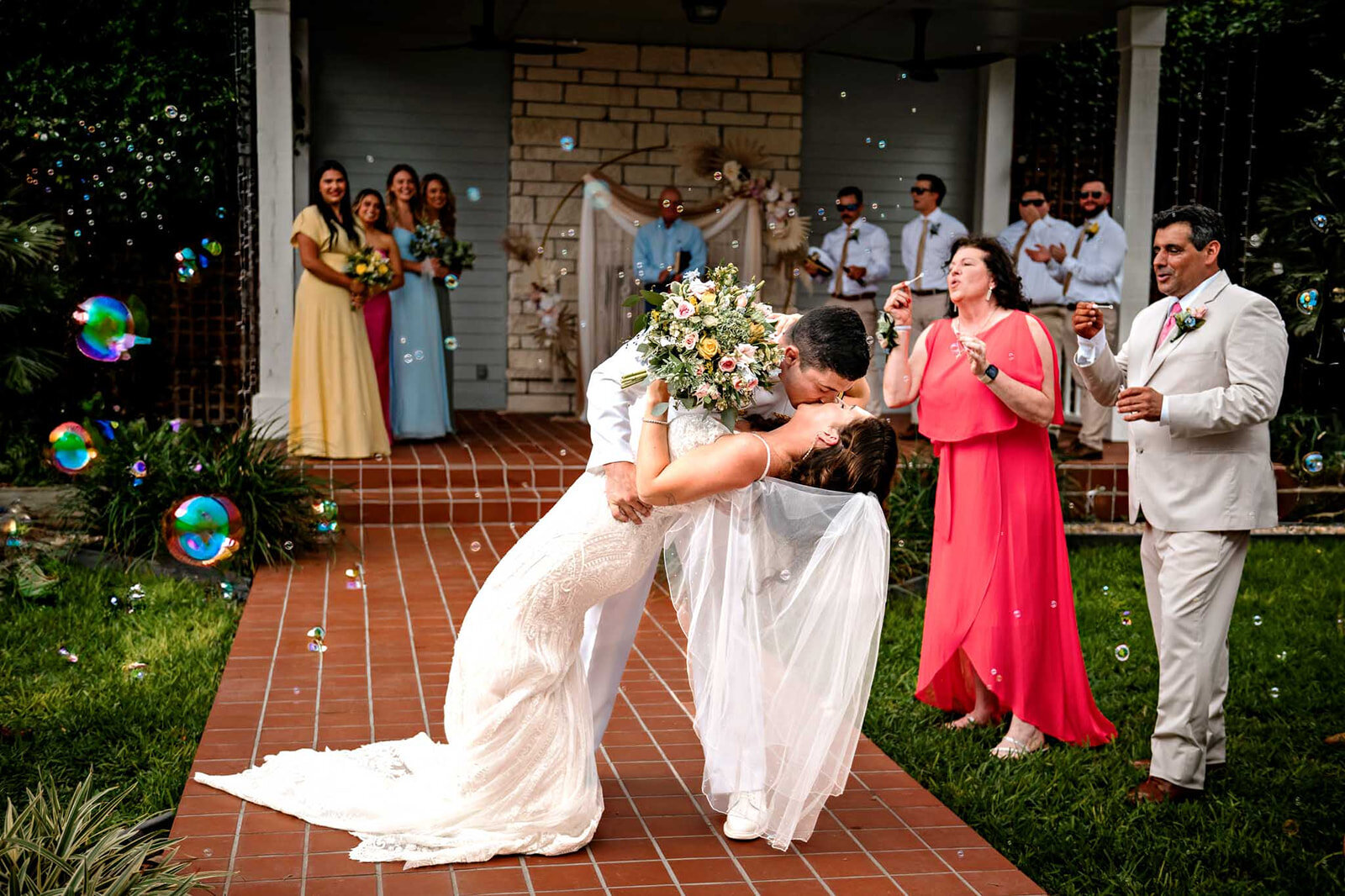 The bride and groom share their first dance in front of friends and family, captured by CMH Studios in San Antonio.
