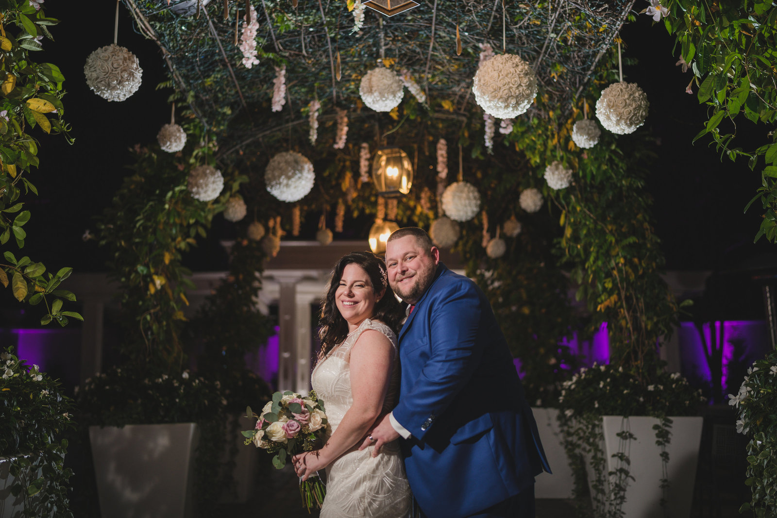 bride and groom posing outside Chateau Briand