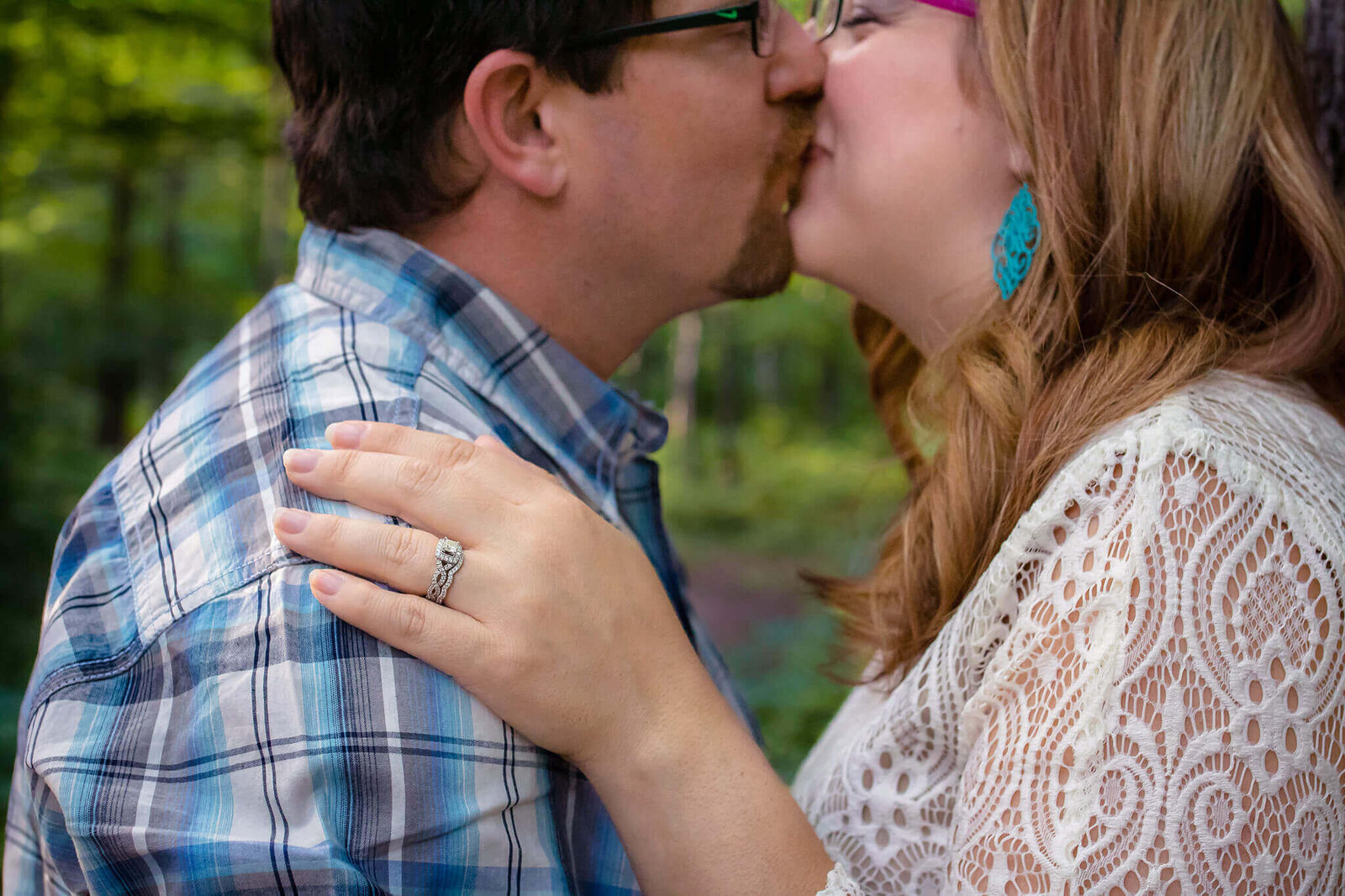 A couple kissing at a park in the spring.