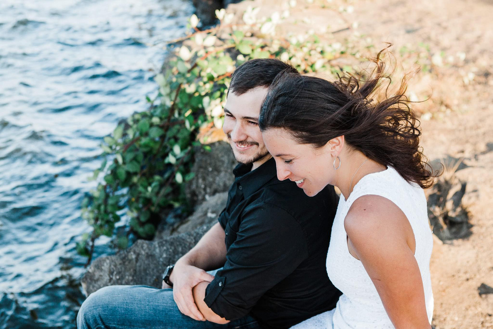 a couple spends time together next to a lake in Seattle during their summer engagement session with Amy Galbraith