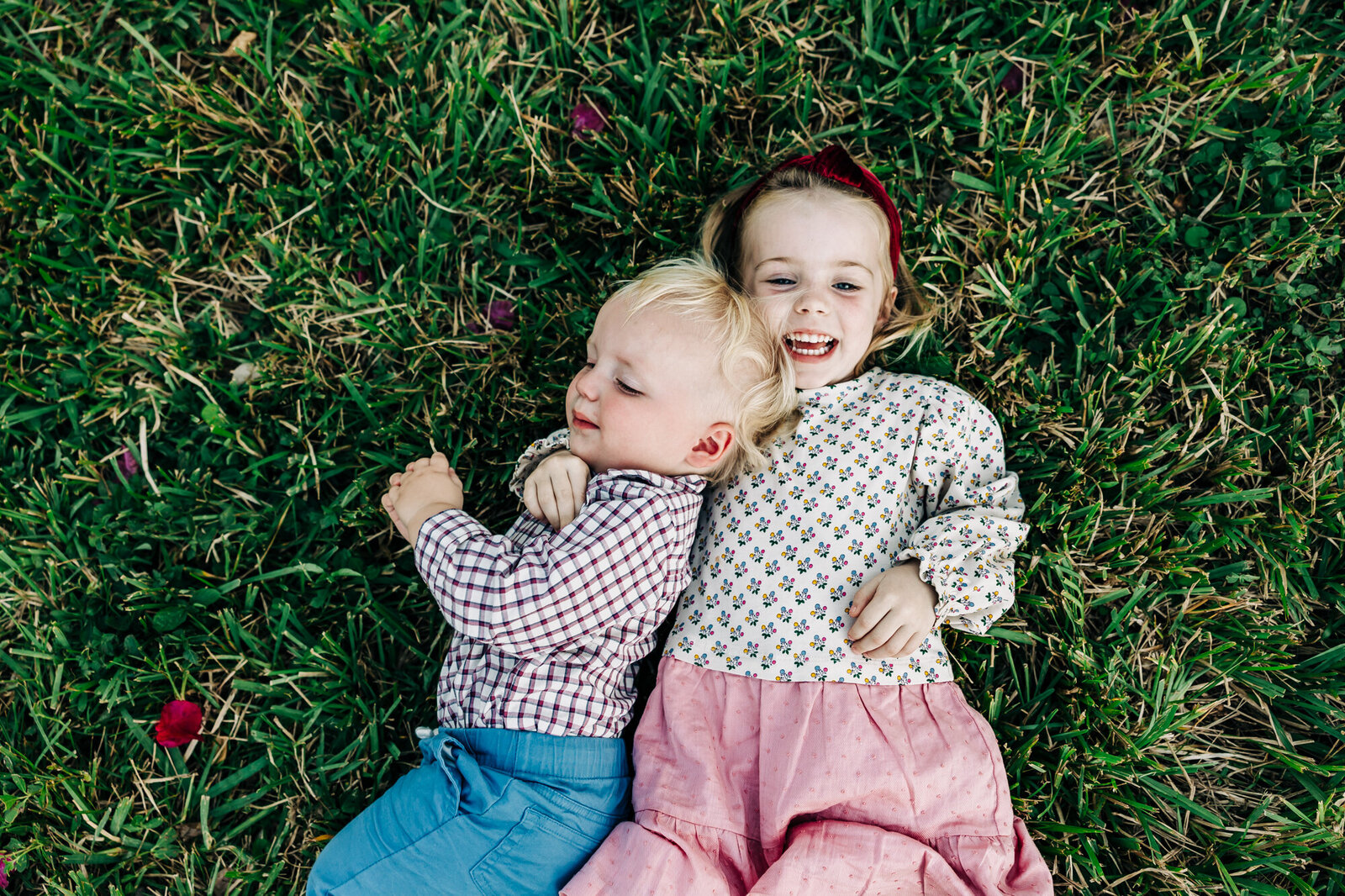 siblings snuggle in the grass near st. pete Coffee Pot bayou