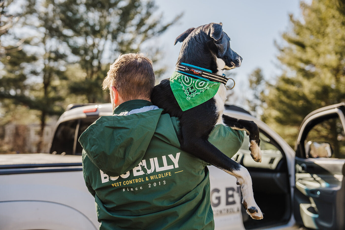 exterminator headshot with dog in front of work truck