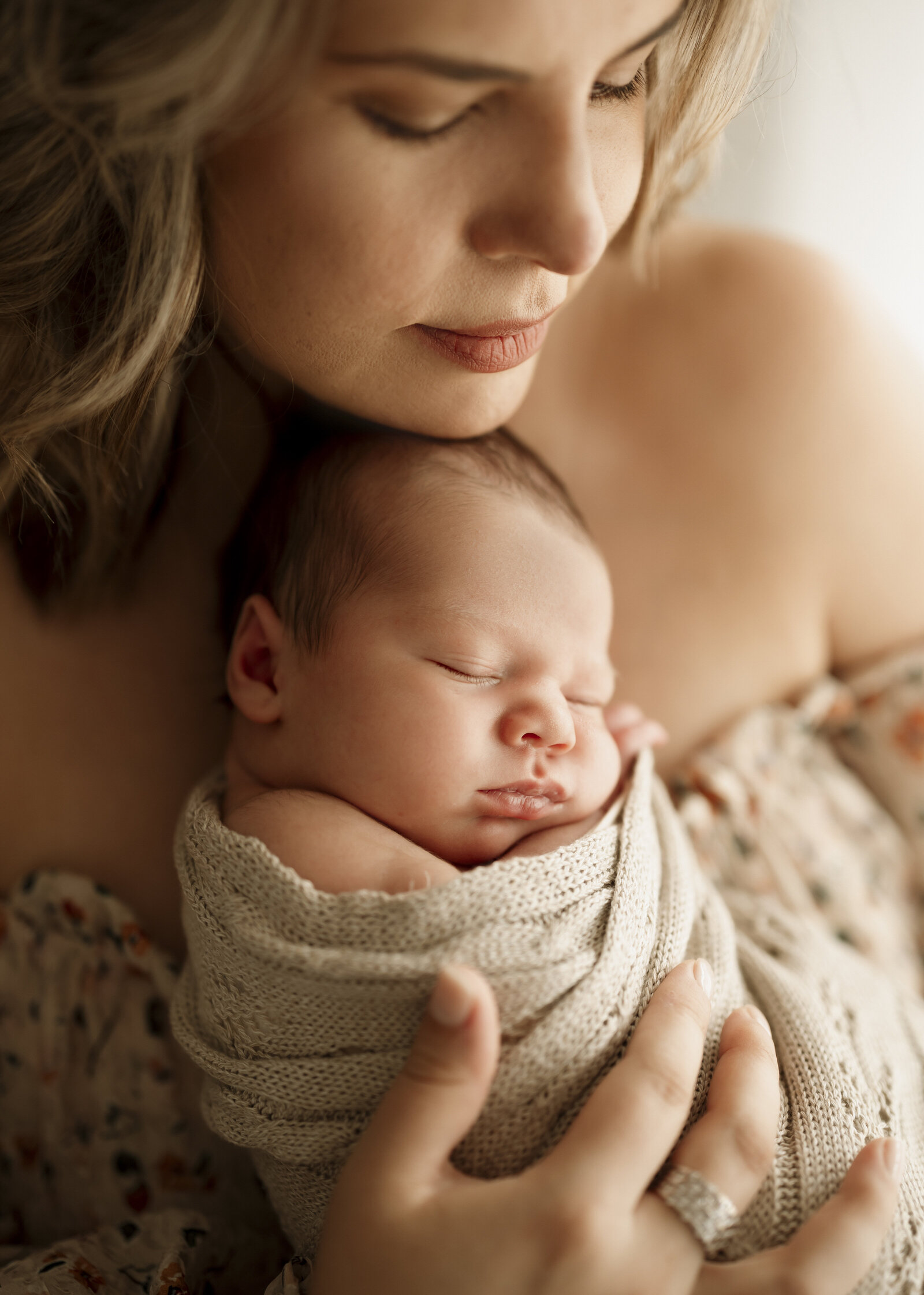 Natural newborn family portraits in a Perth studio – soft, warm, and organic images capturing the love of a growing family.