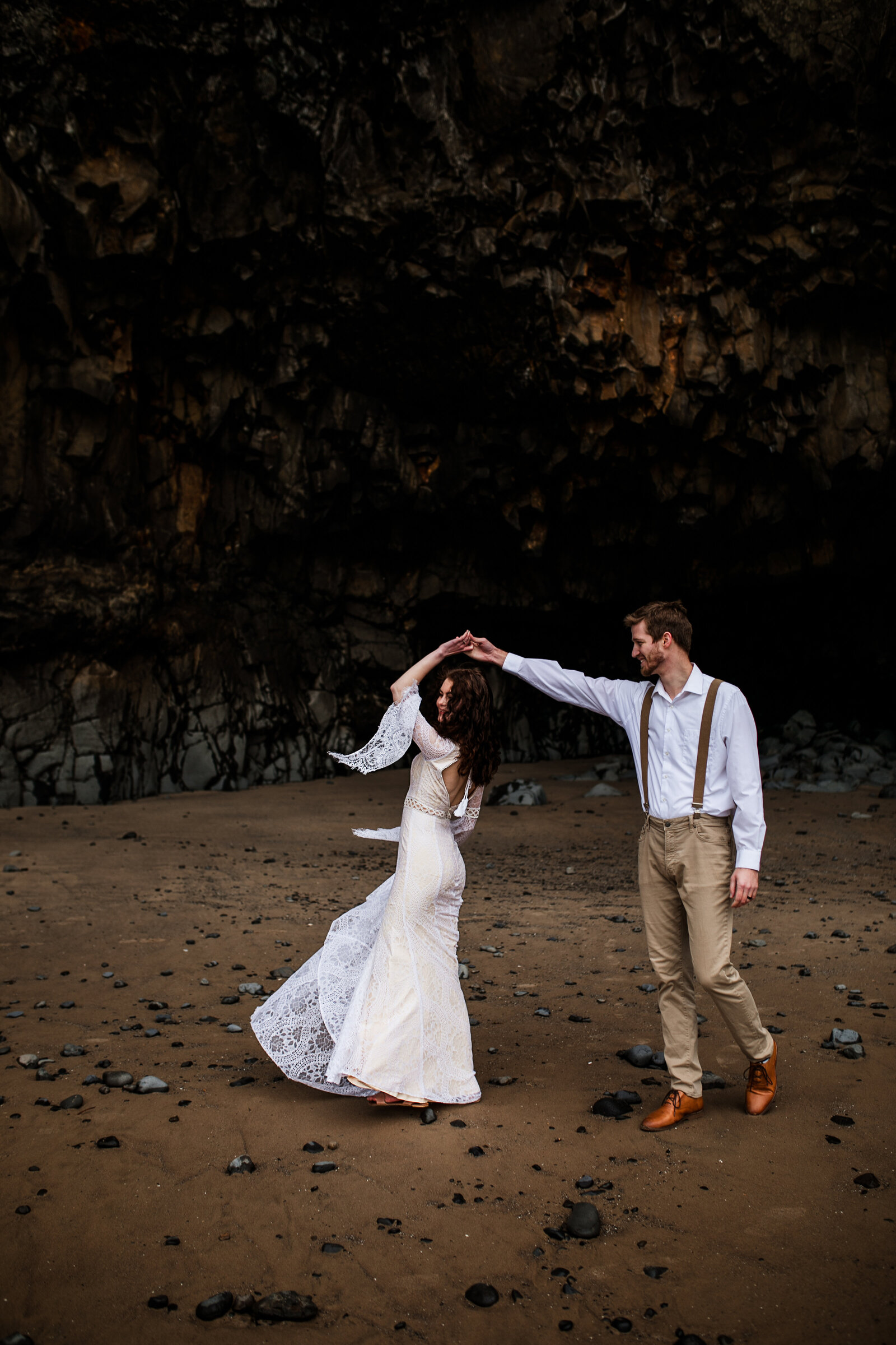 Couple dancing outdoors on rocky terrain with a moody backdrop, highlighting styled shoots for adventurous photographers in the Pacific Northwest.