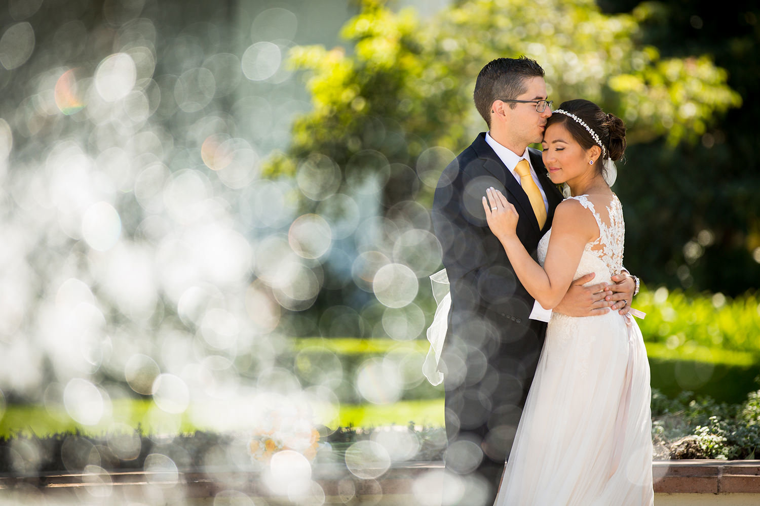 bride and groom in front of the immaculata with fountain