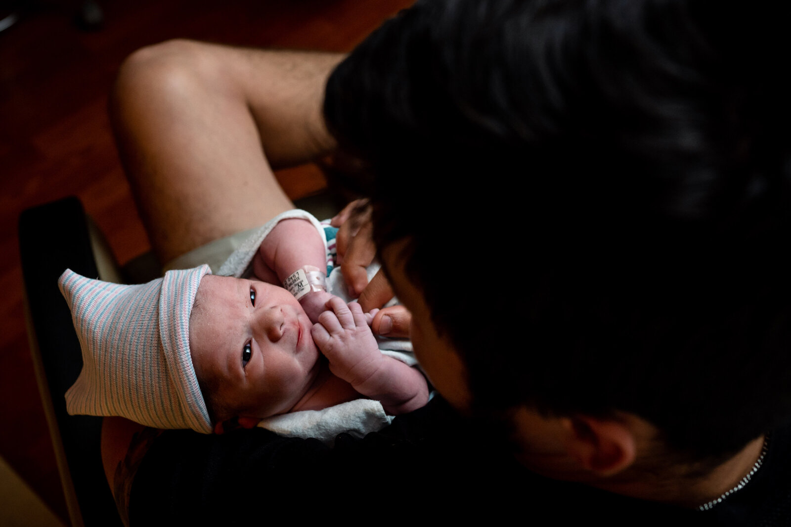 newborn looks up at dad after hospital birth