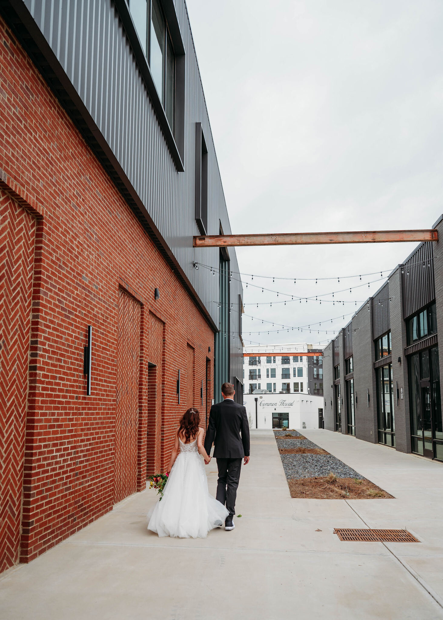 Back view photo of bride and groom walking
