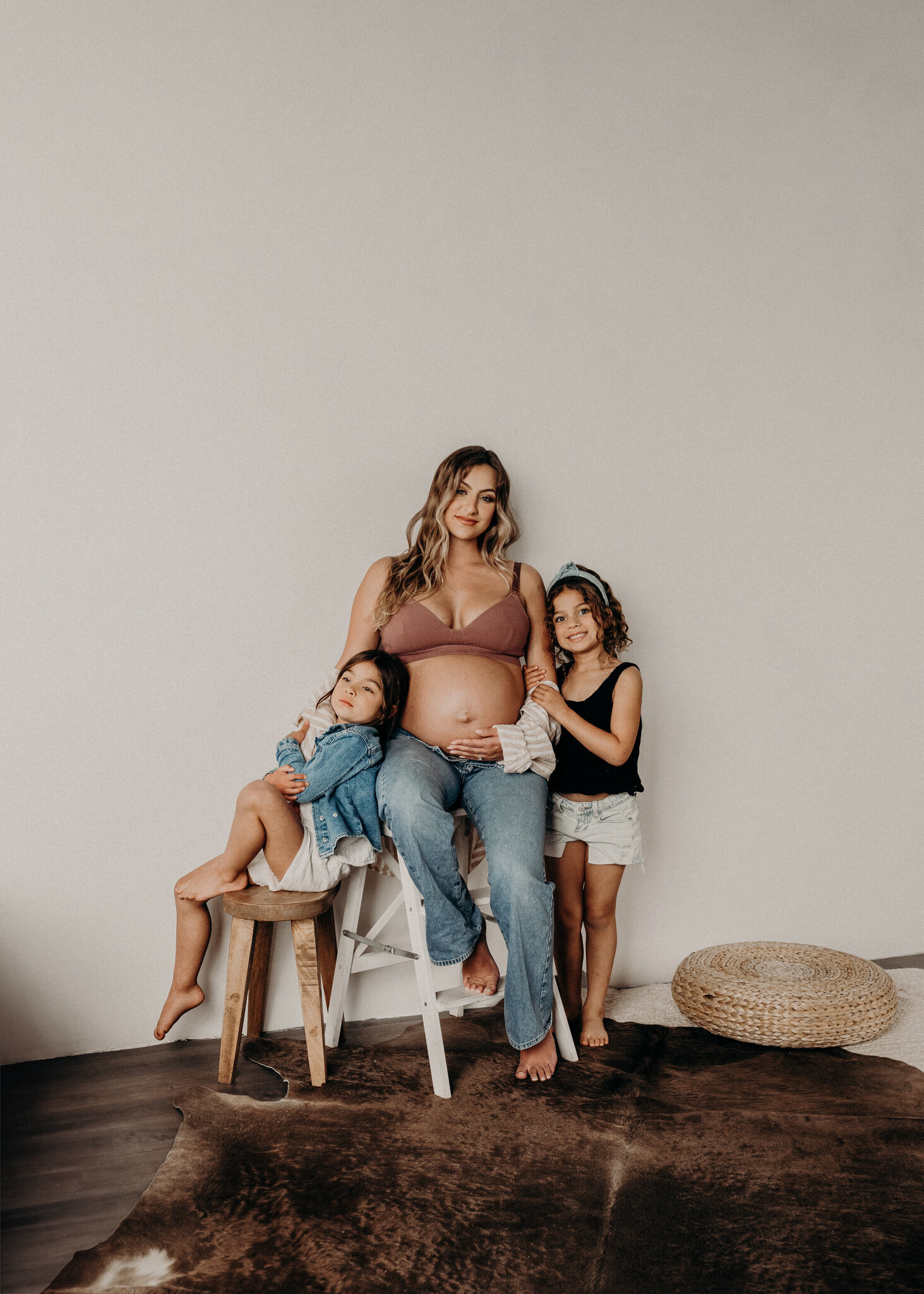 daughters pose with pregnant mom in parker colorado studio