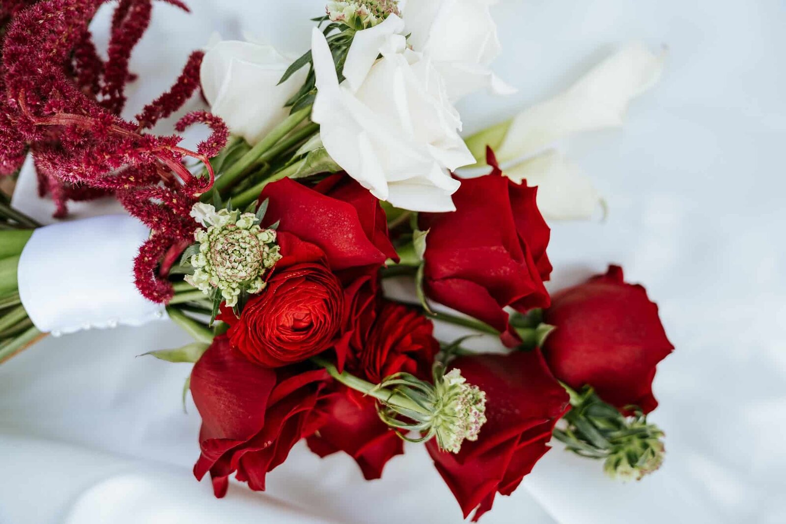 bridal bouquet with red and white roses for Lakeland wedding at the Magnolia building 