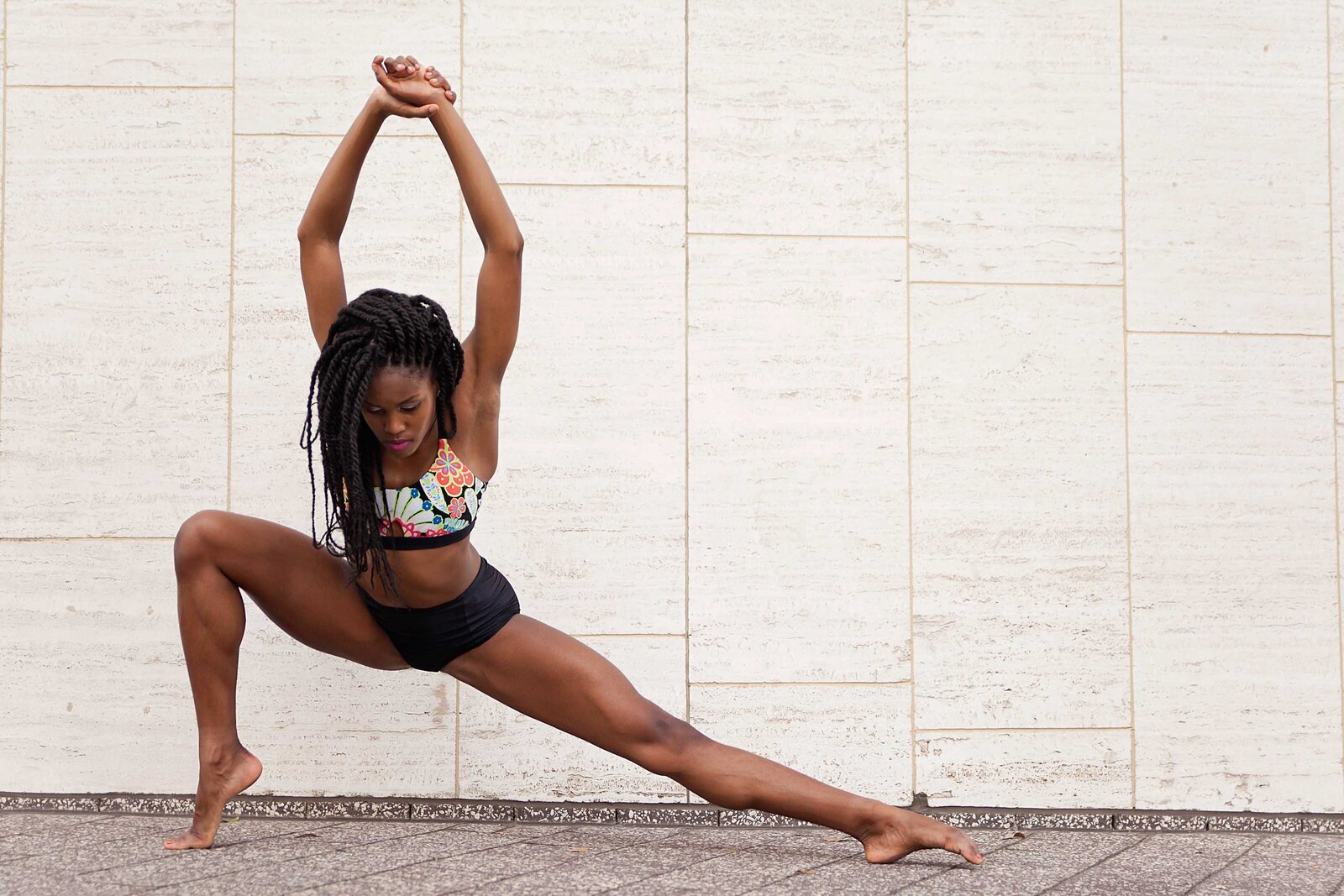 Black woman barefoot dancer stretching
