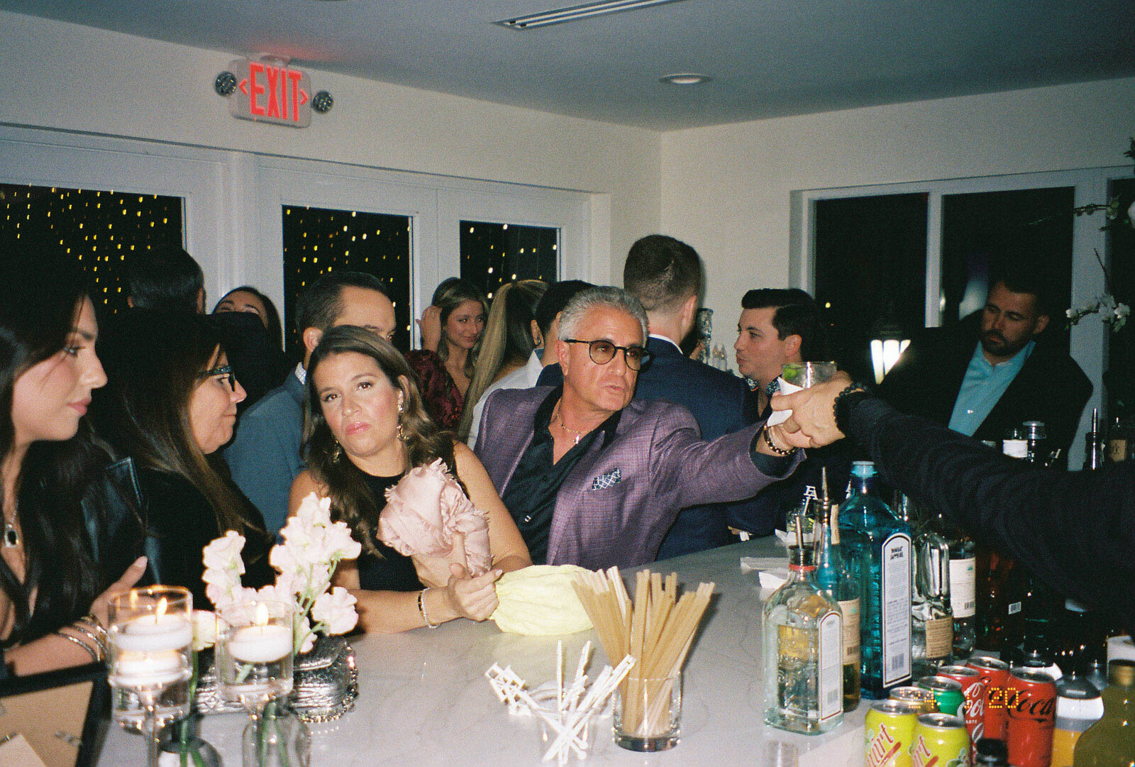 Wedding guests enjoying the bar during the wedding reception to celebrate the new bride and groom