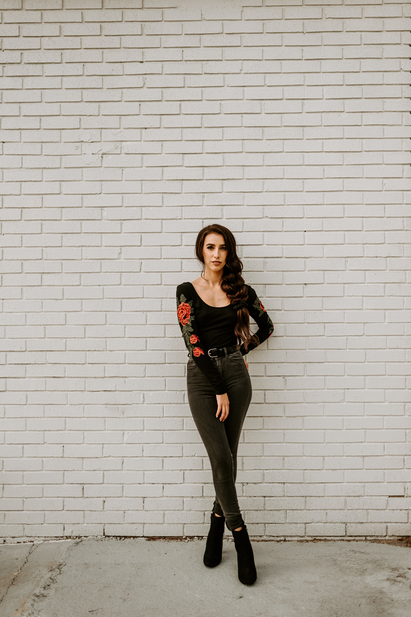 Katlyn standing against a wall