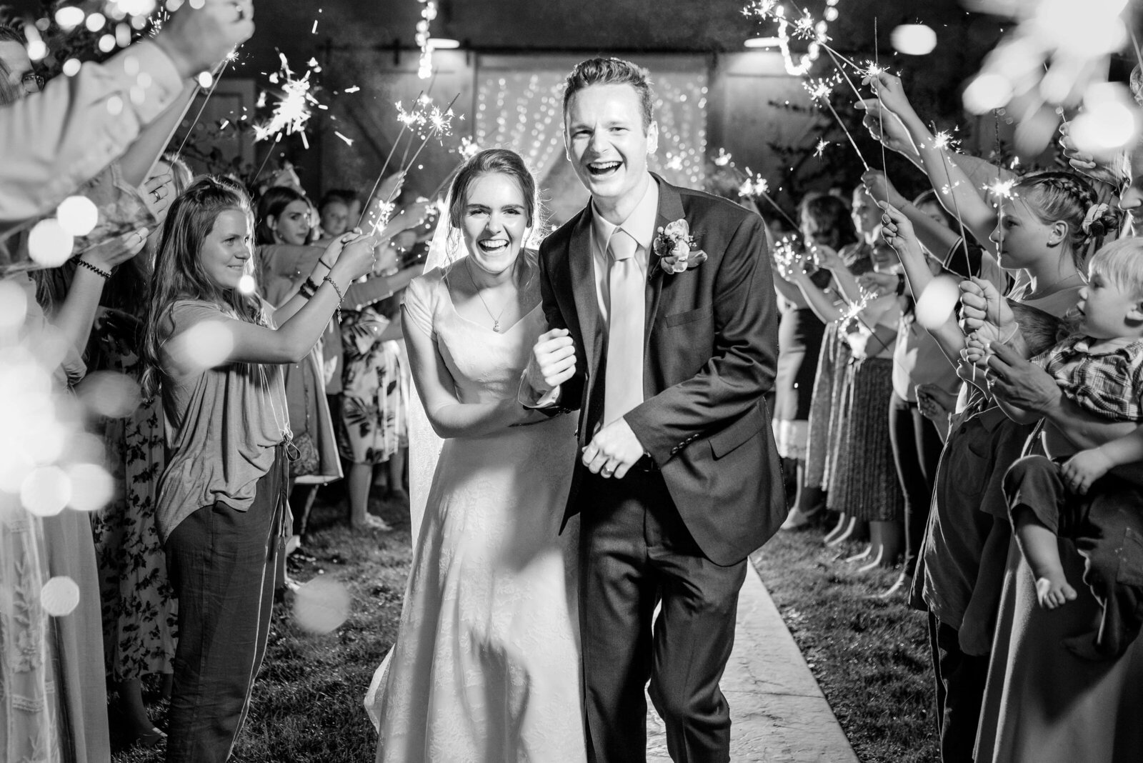 Bride and groom sharing an exciting and emotional moment as they experience their sparkler sendoff at Oak Hills, Utah.