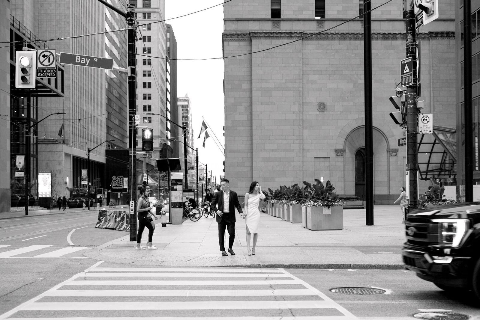 Modern Couple Walking around financial district downtown toronto engagement session toronto wedding photographer jacqueline james photography