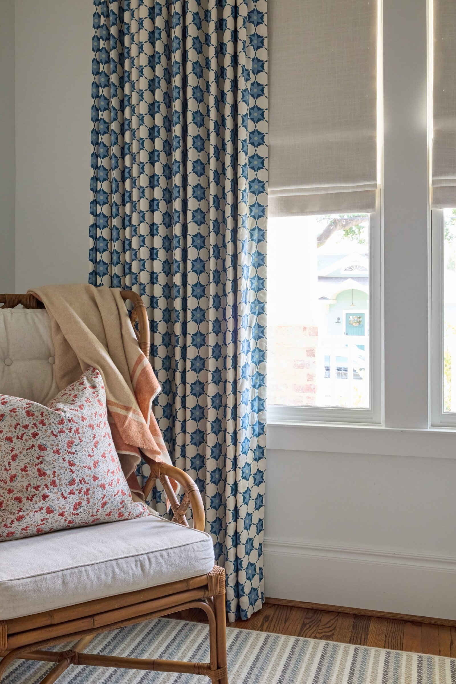 vision and hammer sitting area with wooden chair and blue and white accented curtains
