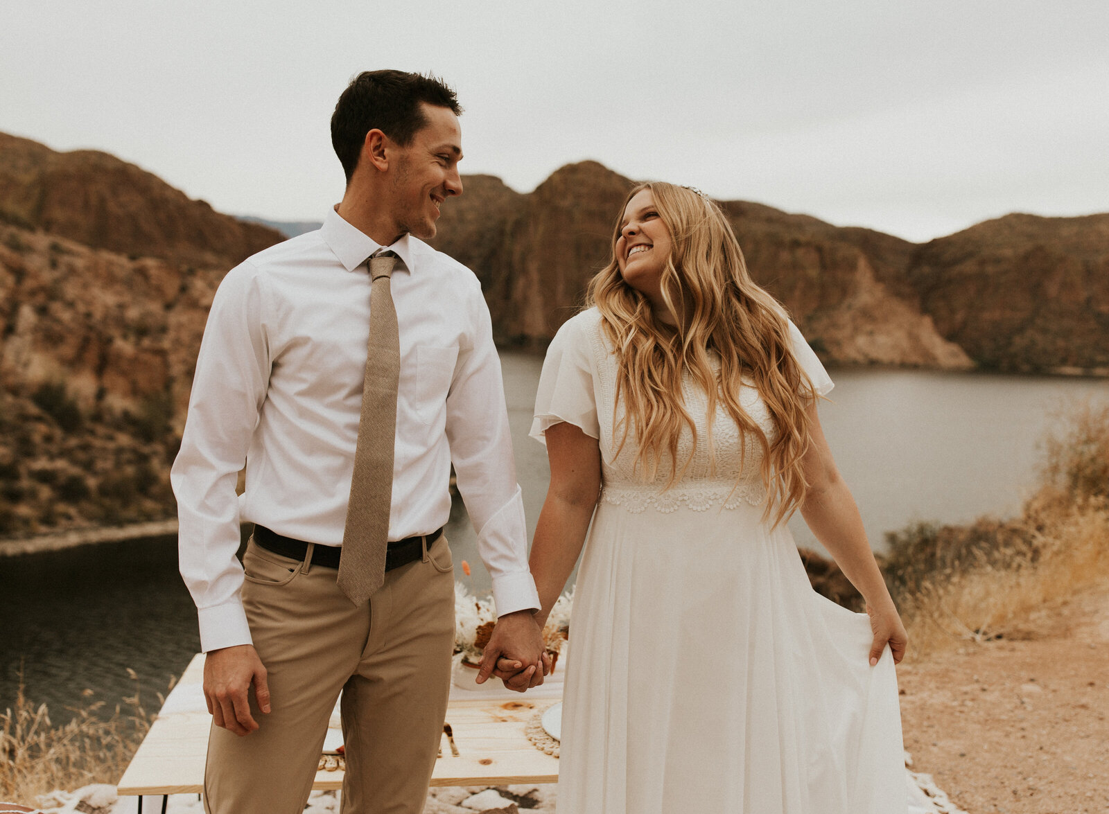 Bridals wedding photography in the Grand Tetons. The bride and groom and looking into each others eyes and smiling with the Tetons behind them.