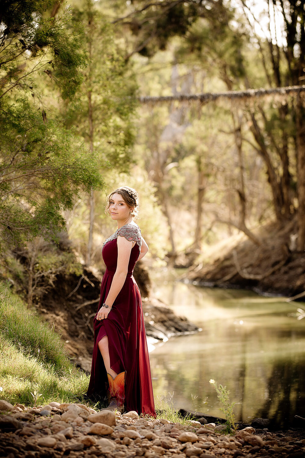 senior portrait of girl by a river