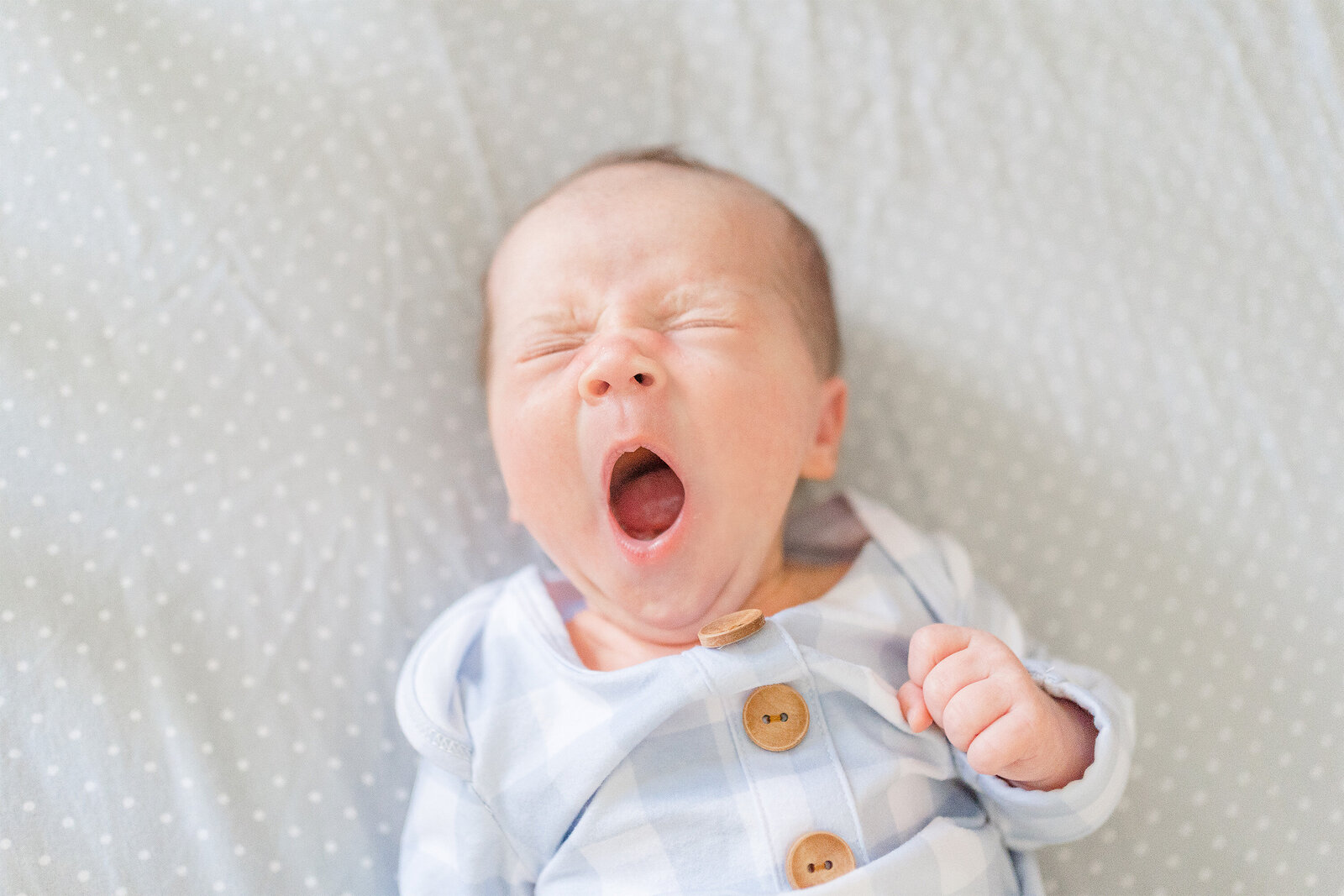 baby boy yawning, taken in Fairfax, Virginia during  photoshoot, taken by a Northern VA newborn photographer