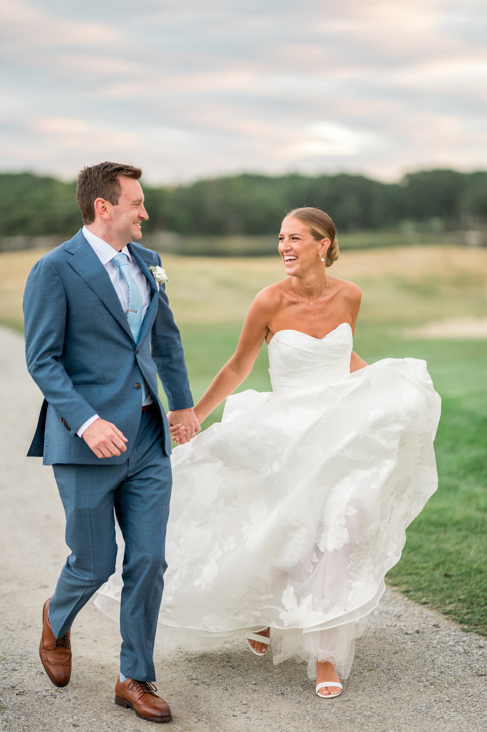 Bride and groom running together at their Wentworth by the Sea Country Club wedding — bright, airy, joyful photography by Sarah Surette Photography.”