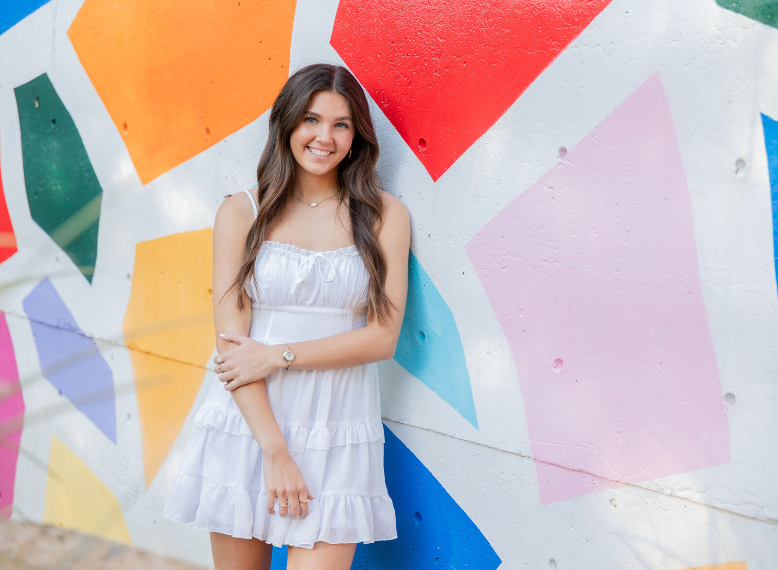 senior girl with bright mural