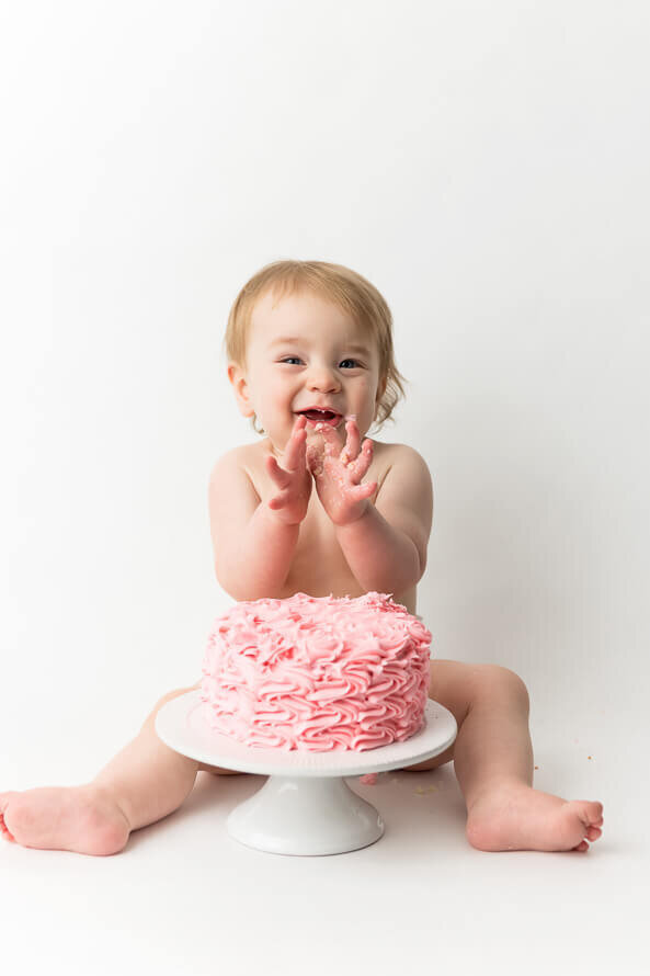Cake smash photo with a pink cake.