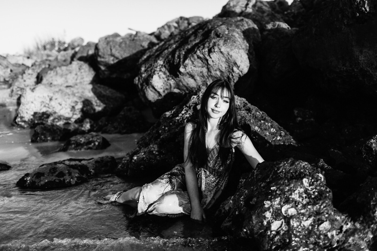 Senior Portraits Naples Beach Sitting In The Water By Rocks