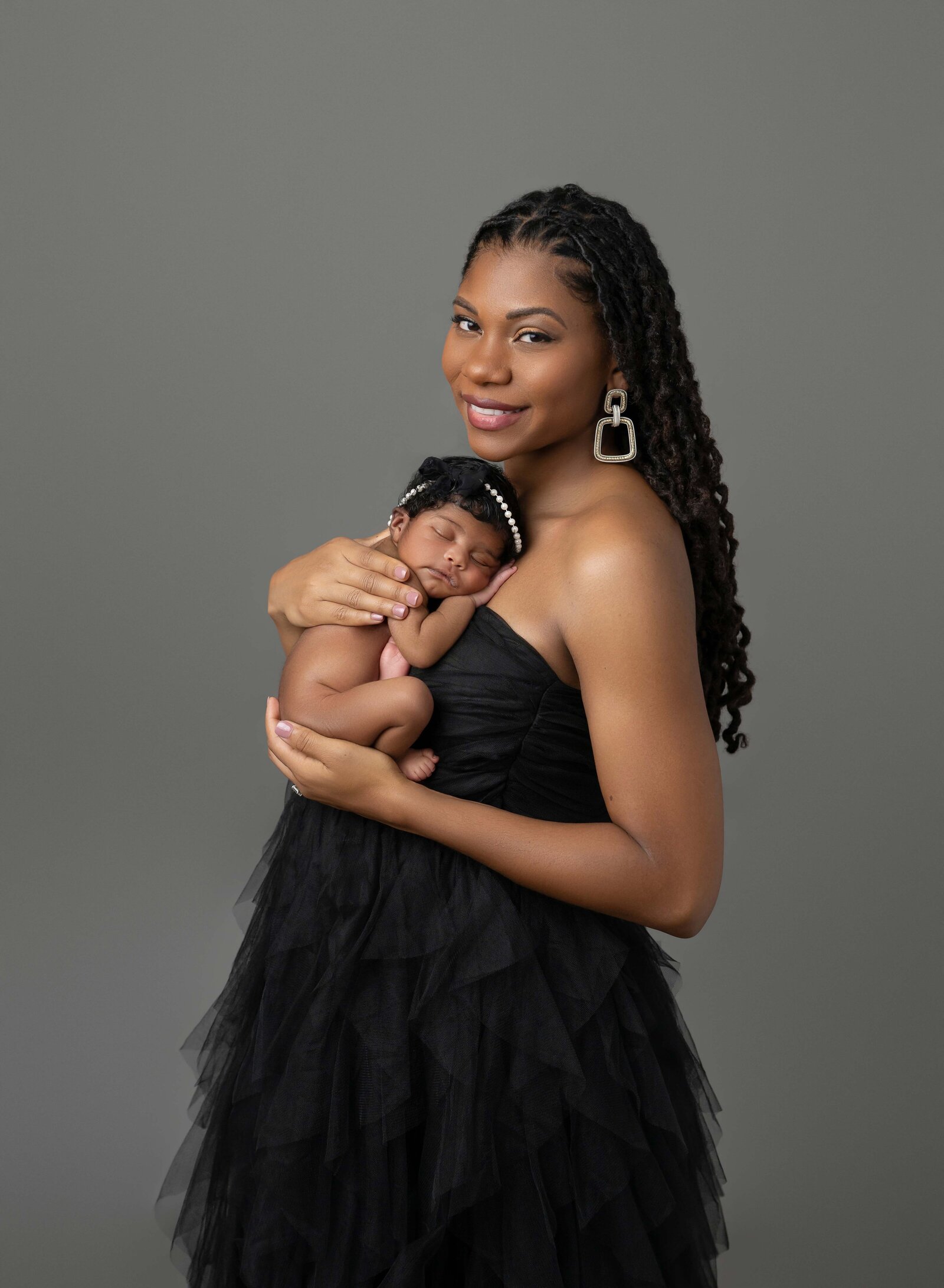 Newborn baby photo of her asleep on Mom's chest. Photographed by Jenni Nikki Photography at Marietta Newborn Photo Studio.