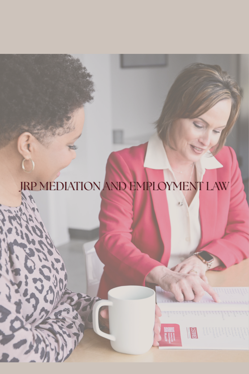 alt="Jennifer R Petersen in a pink blazer consulting with a client in a business meeting, JRP Mediation and Employment Law Firm"
