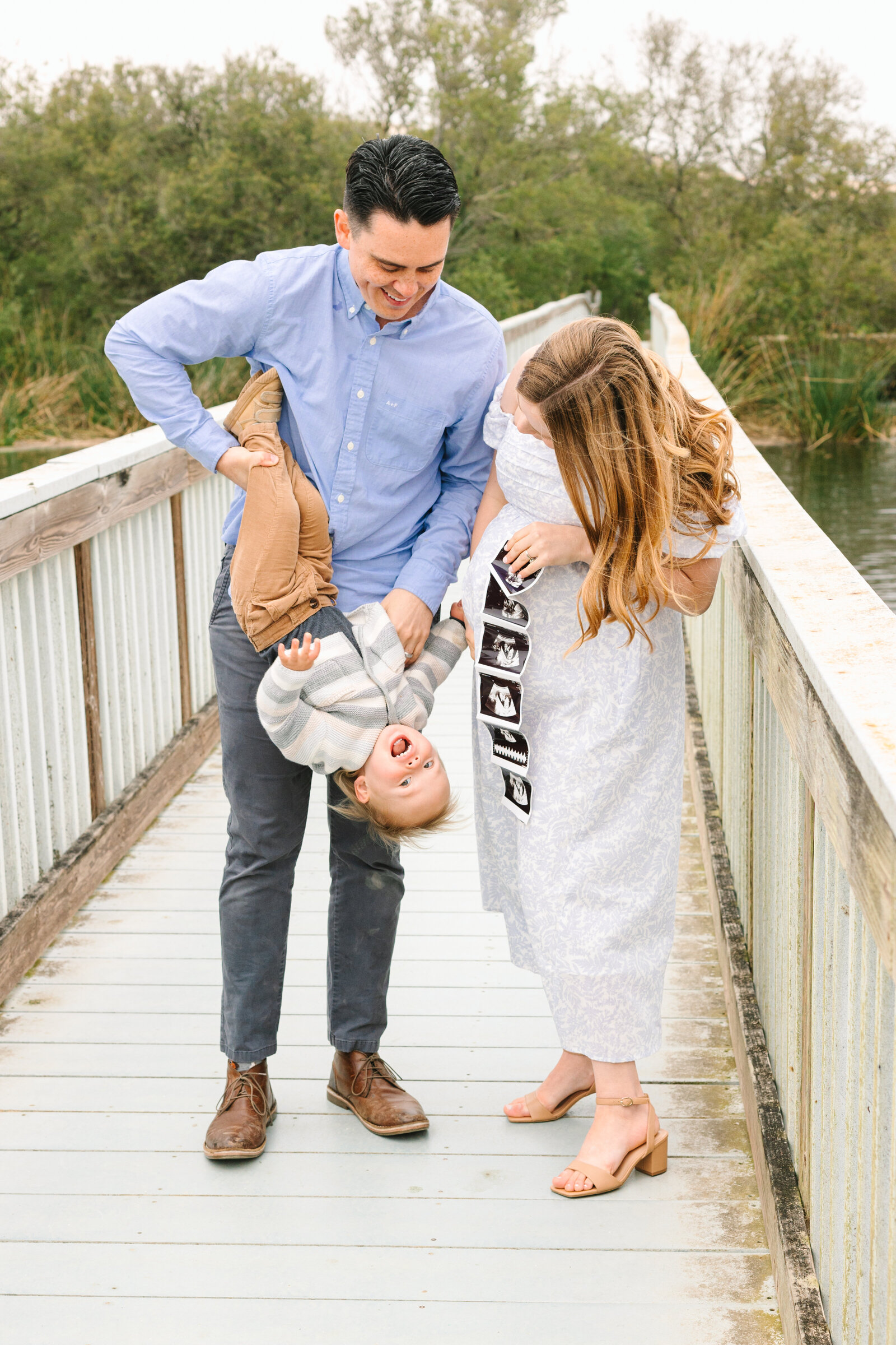 A pregnant woman poses for maternity photos with her family in Los Angeles, Ca.