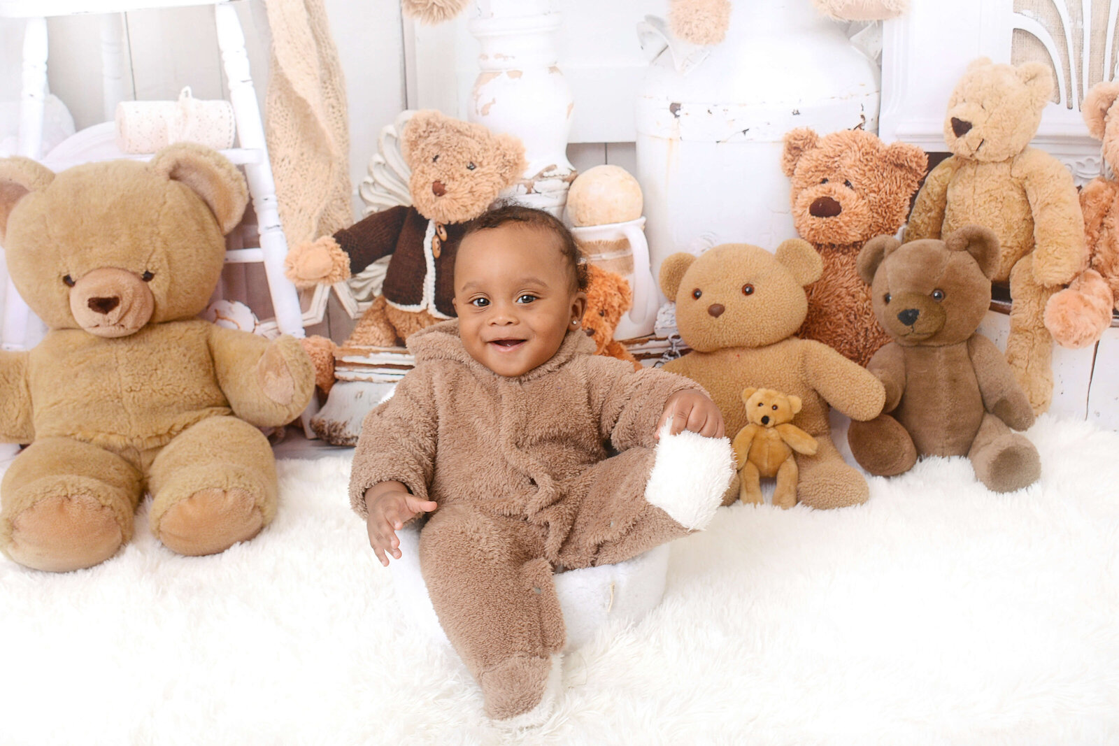 boy smiles at a teddy beat themed milestone photoshoot