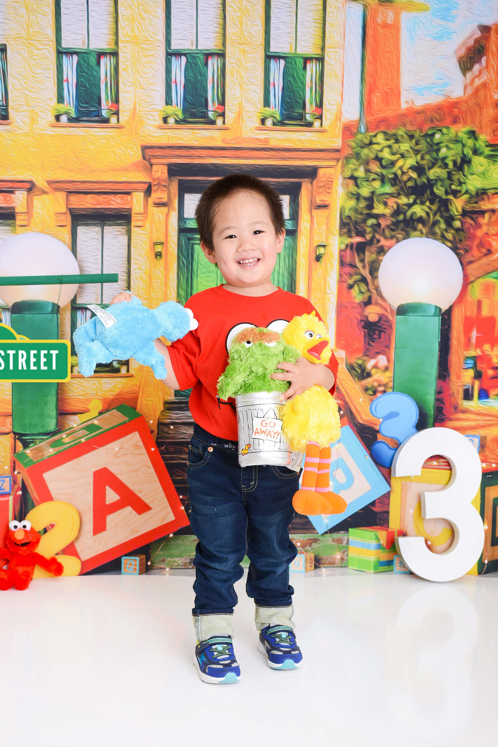 boy smiles at a sesame street themed shoot in houston