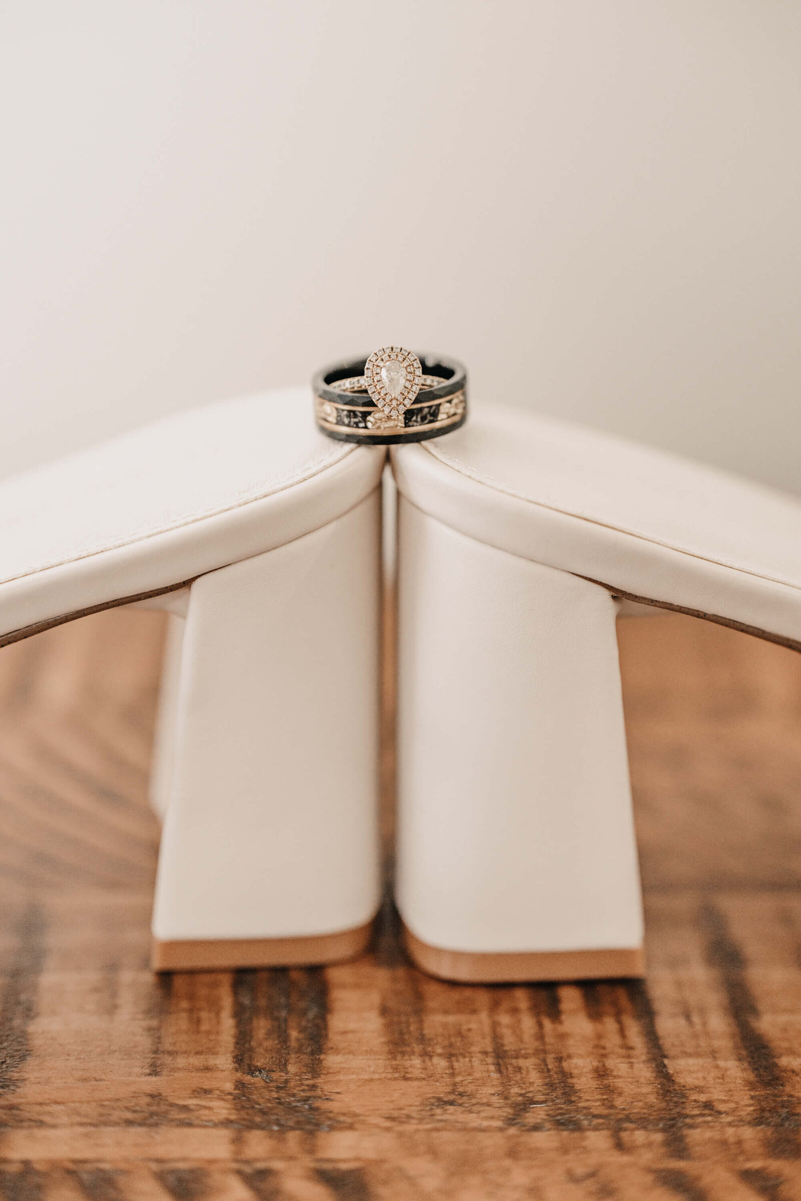 A wedding ring elegantly placed atop a pair of pristine white shoes, symbolizing love and commitment.