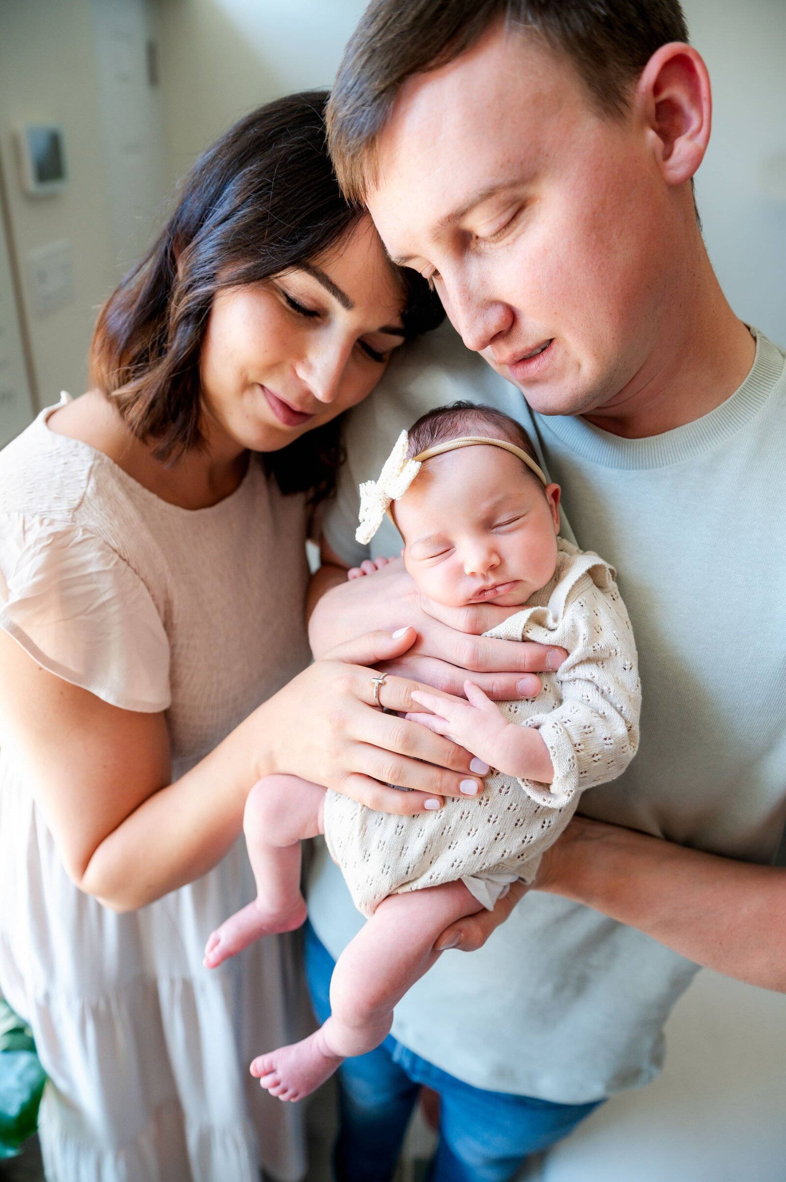 parents holding newborn baby girl