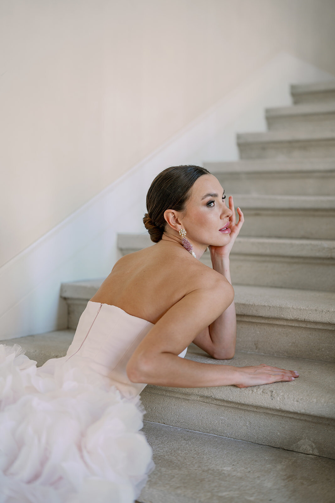 Elegant editorial bridal portrait of bride resting on staircase during romantic Chicago wedding, captured by Raechel Marie Photo.