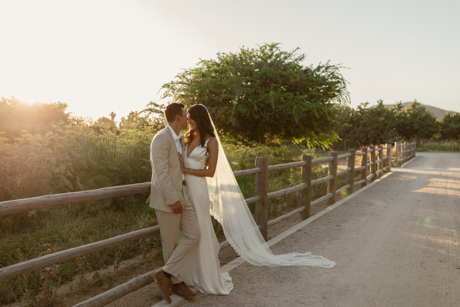 bride and groom smiling together at golden hour