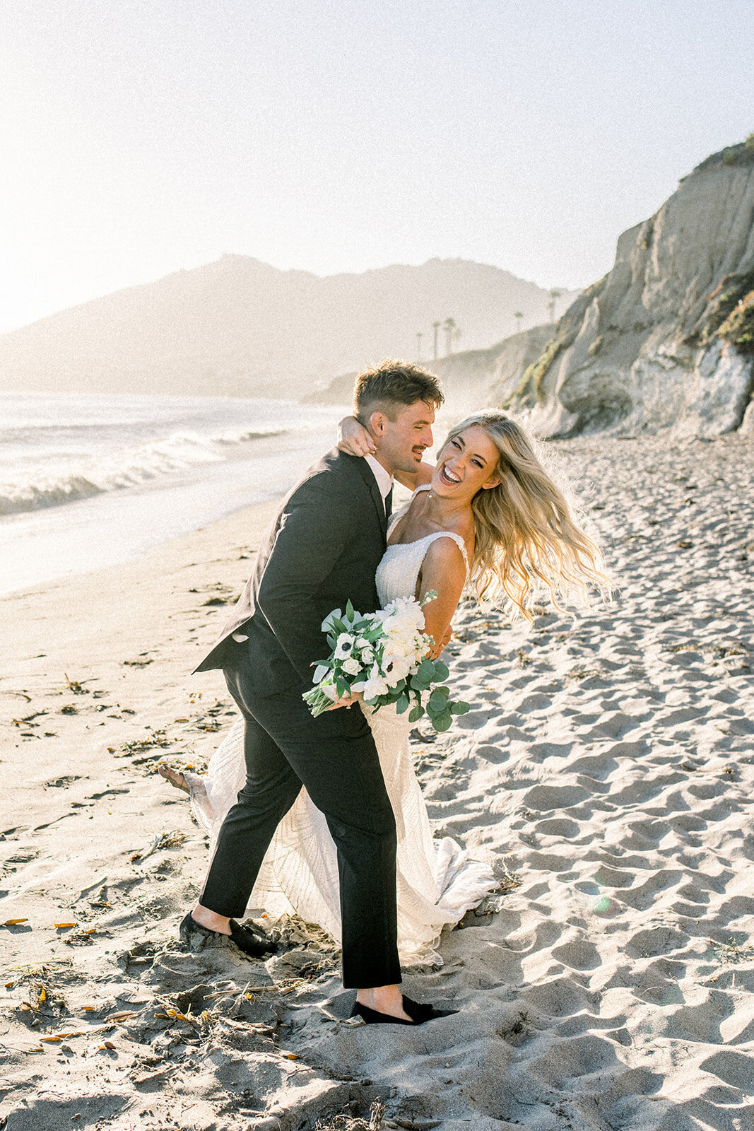 Bride and groom on the beach at Dolphin Bay Resort wedding in Pismo Beach, CA