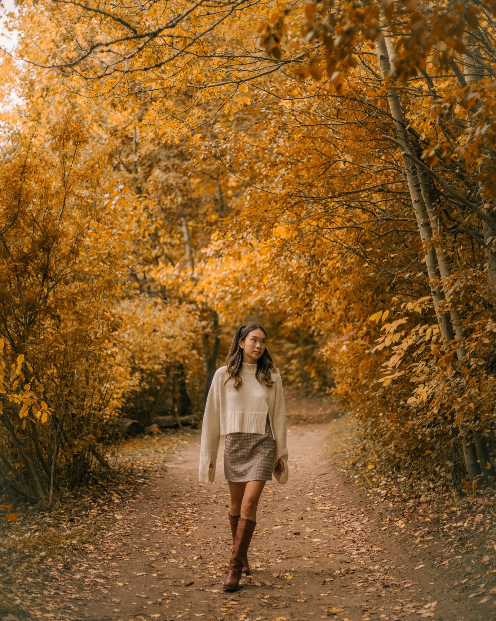 woman-walking-through-park-in-autumn