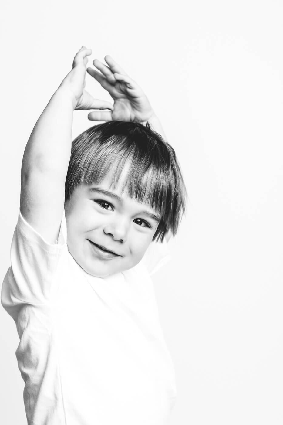 Monochrome of child lifting his hands above his head