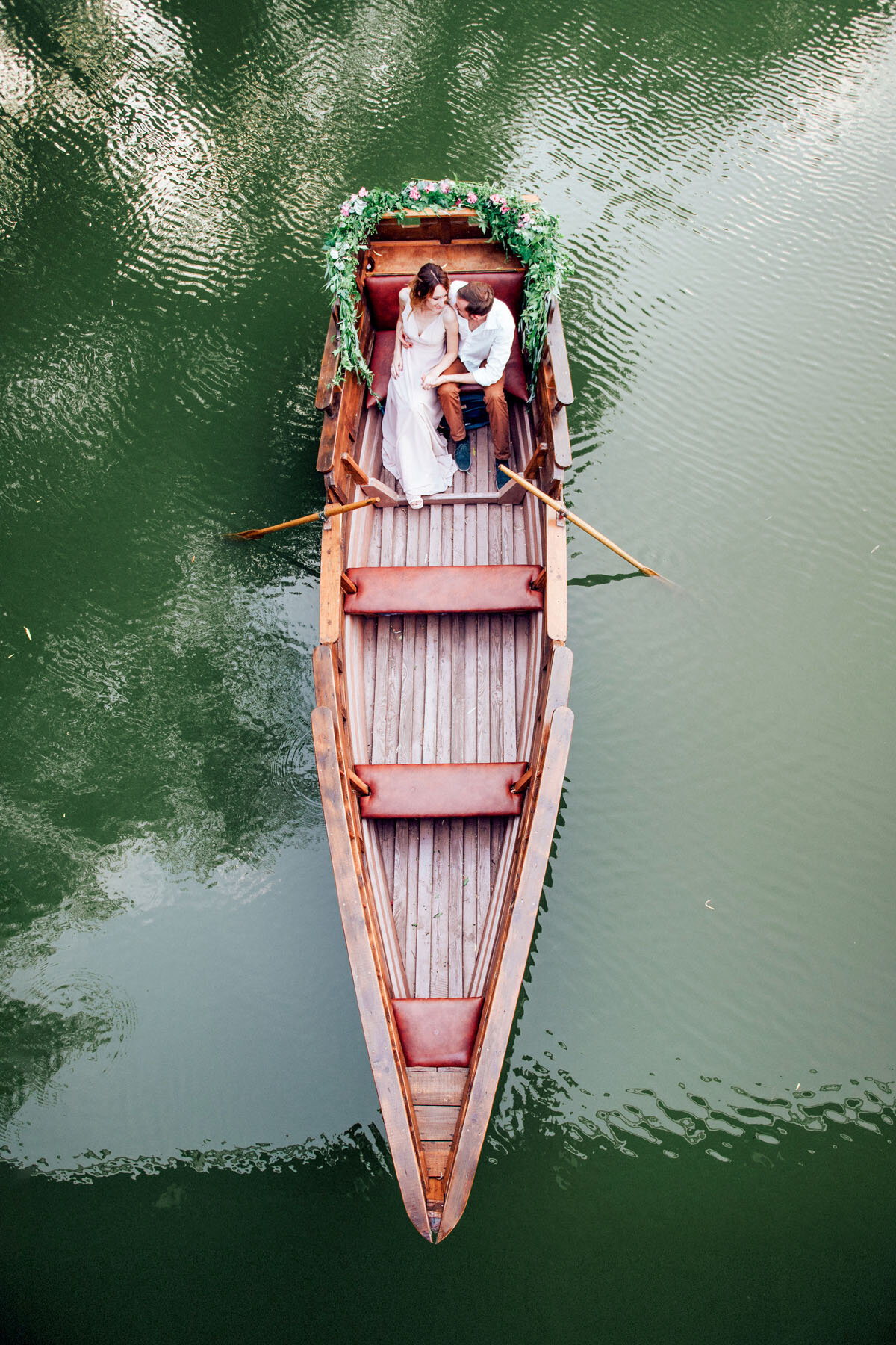 Dockside photo of bride and groom on a boat.
